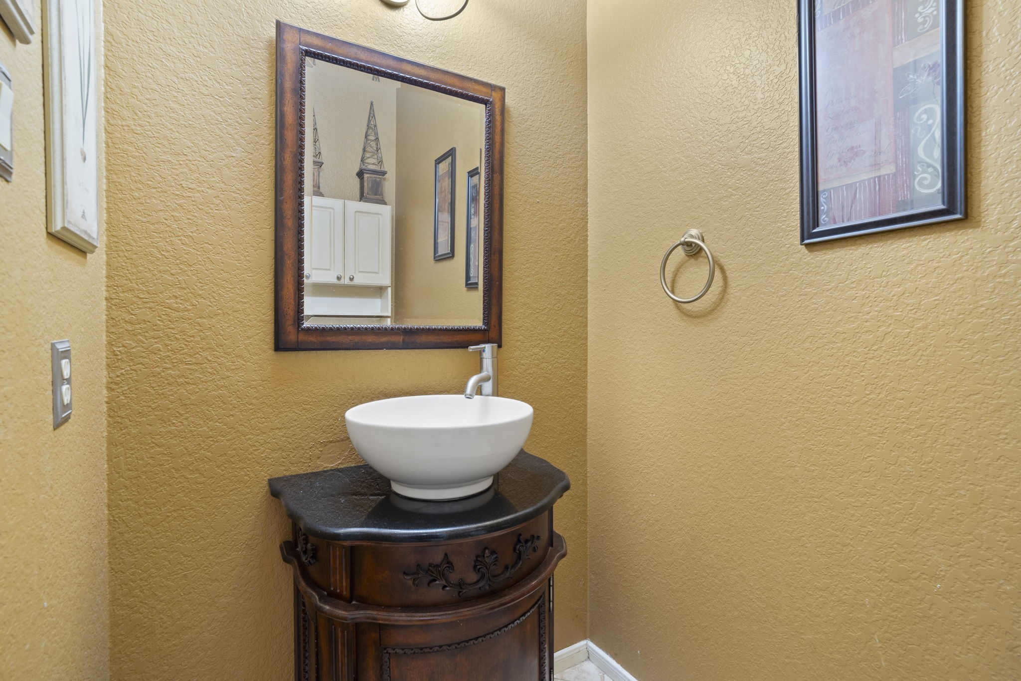 A conveniently located first-floor half bath sits at the center of the home, providing easy access and comfort for guests.