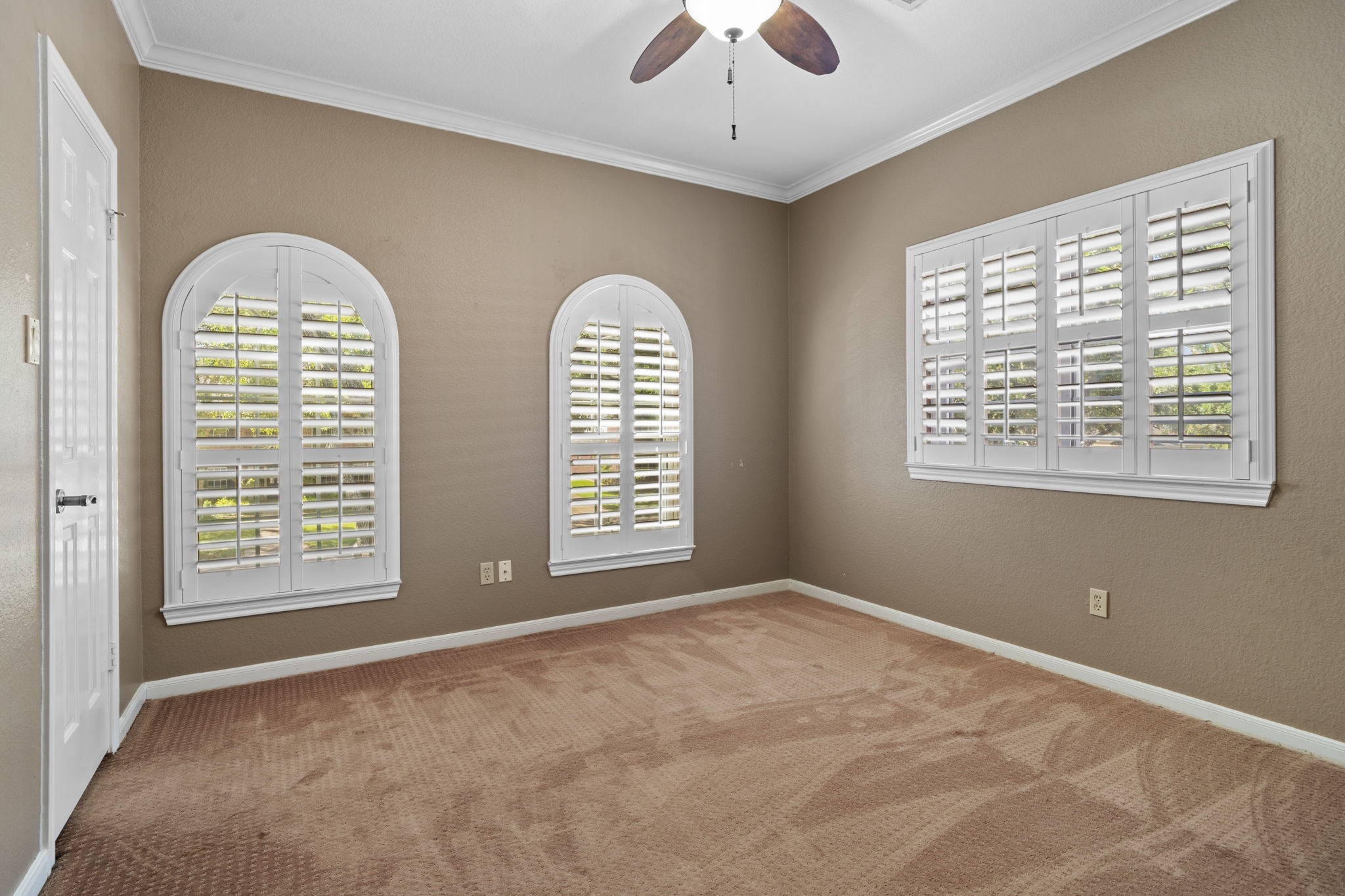 All windows are fitted with custom plantation shutters, offering timeless style along with adjustable privacy and shade as needed.