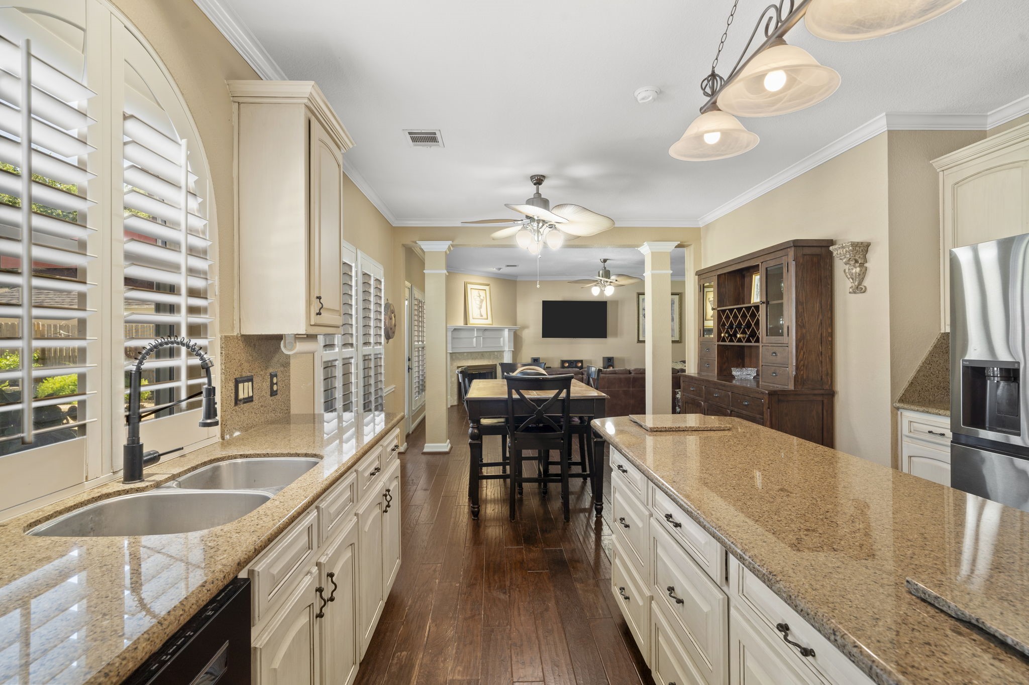 Smartly designed kitchen features a large center island with expansive counter space and loads of storage.