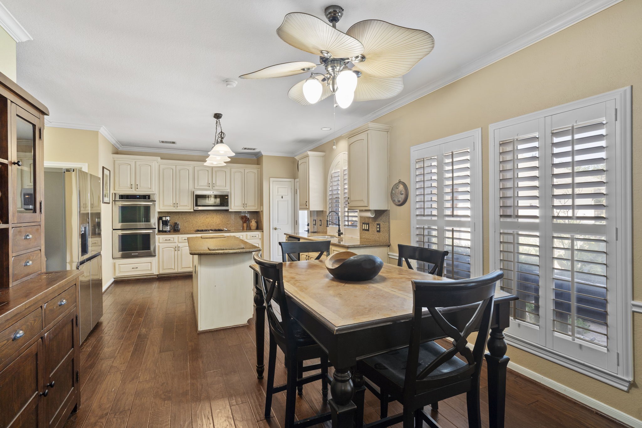 Youll love the kitchen and breakfast area, bright and inviting, with windows that overlook the patio and pool, creating a cheerful space for daily meals and gatherings.