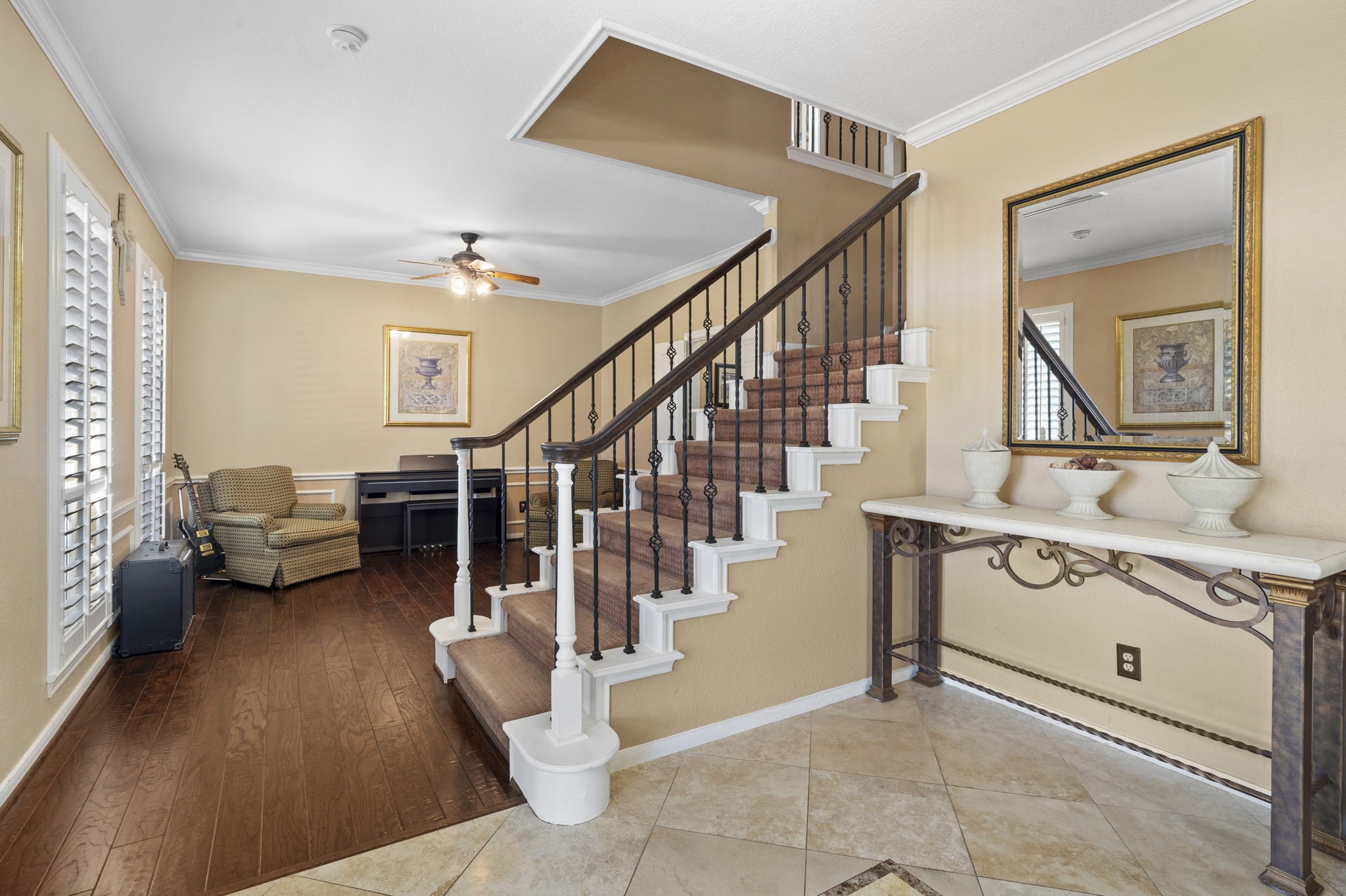 Steps lead to a private living area that houses all the bedrooms and two full bathrooms, offering a secluded retreat within the home.