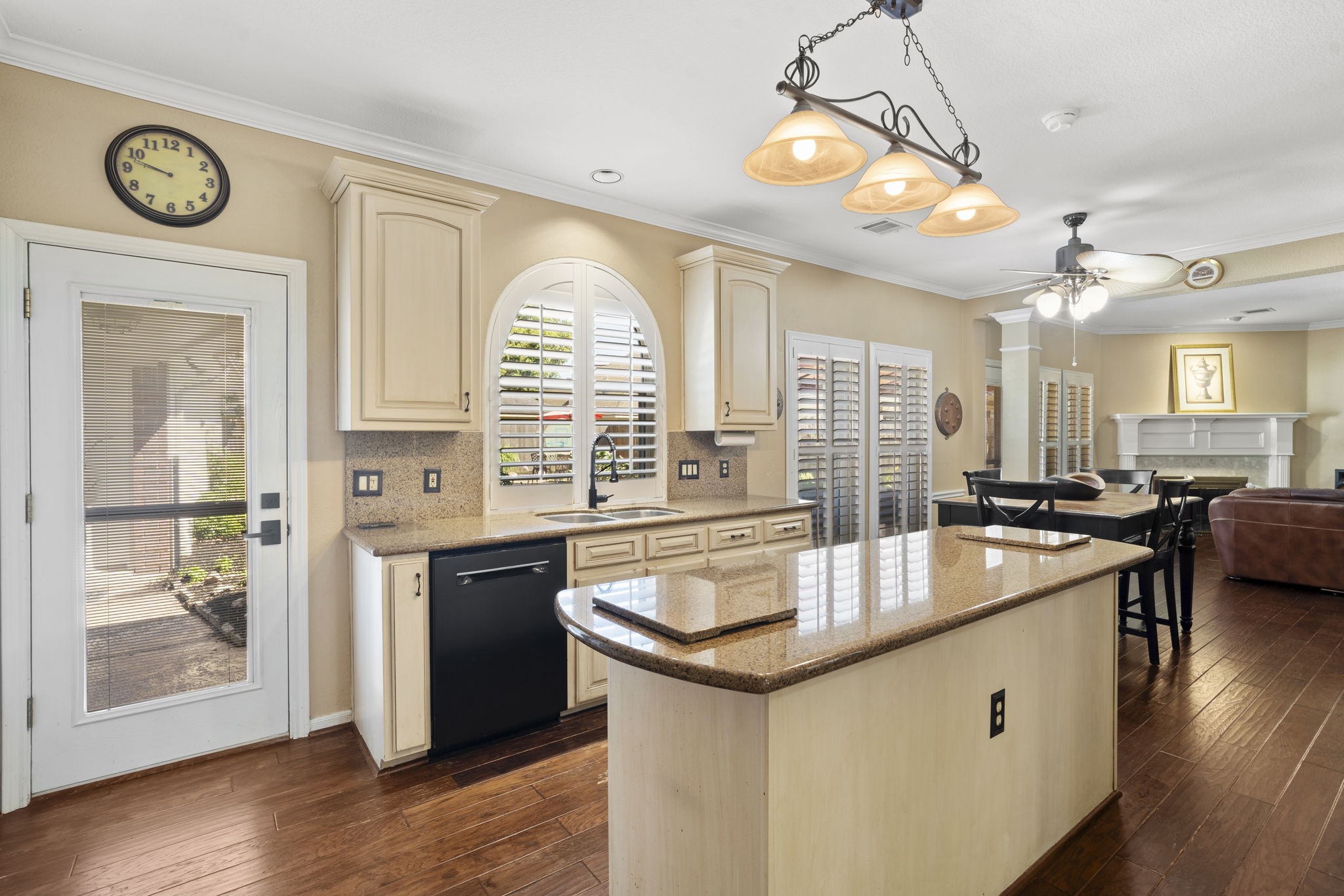 The kitchen is thoughtfully designed with granite countertops, soft-close cabinets and drawers, under-cabinet lighting, dedicated pot and pan drawers, and a spacious walk-in pantry.