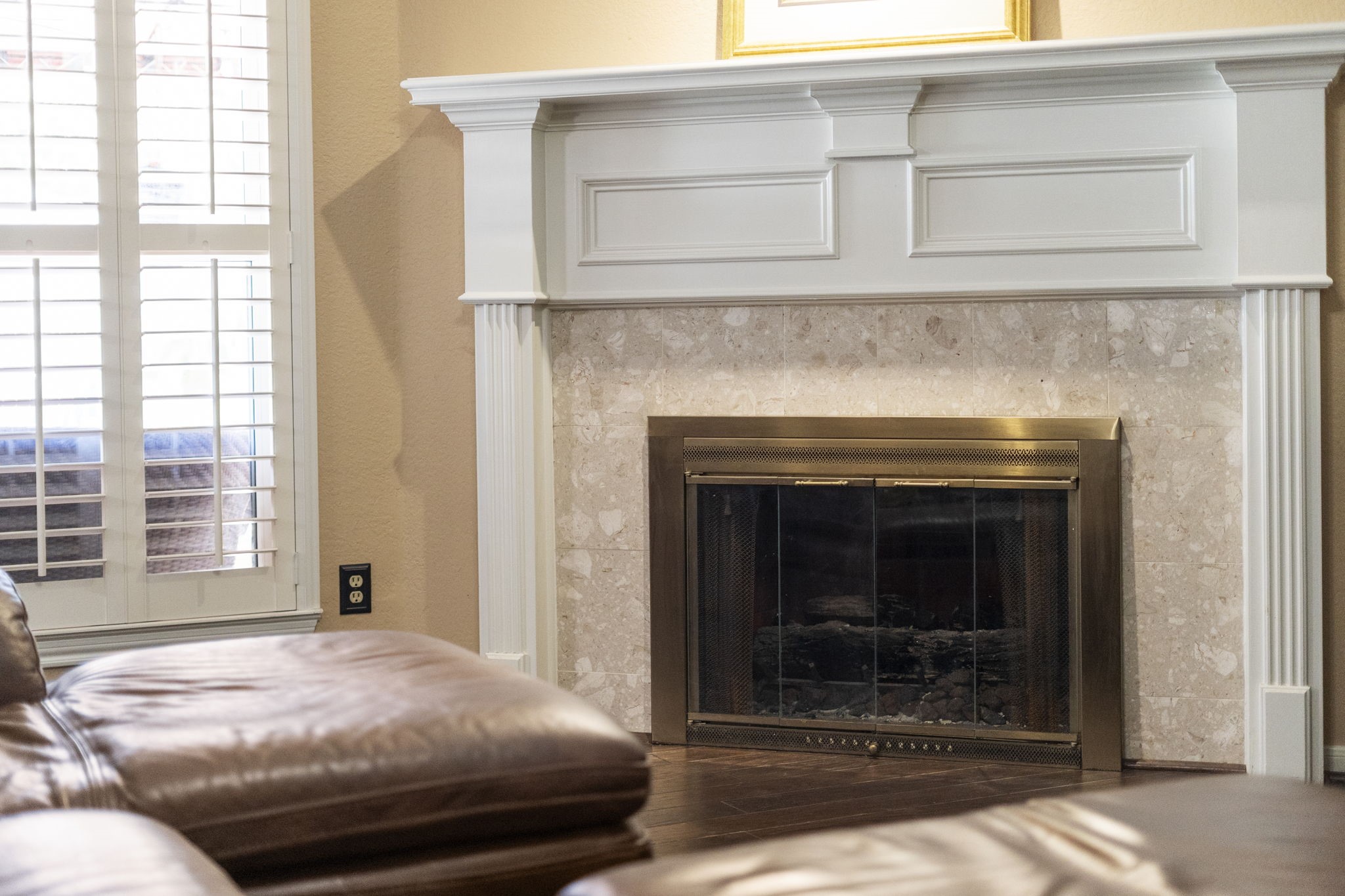 The classically designed fireplace offers timeless appeal, while convenient gas logs provide warmth and ambiance with no maintenance required.