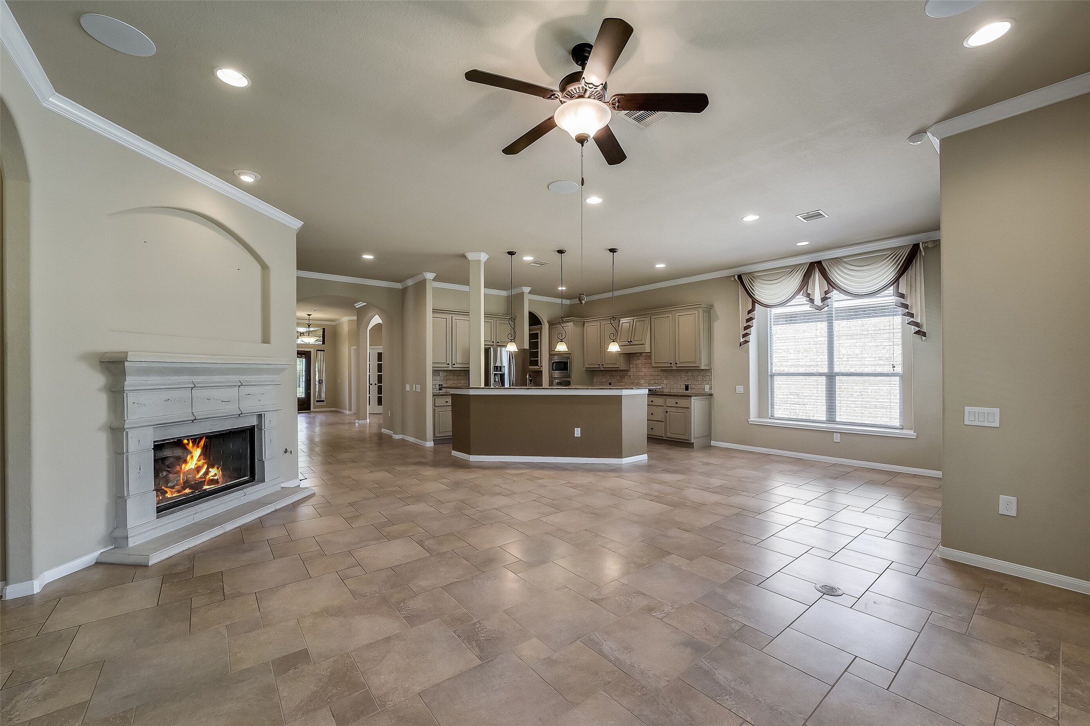 The cast stone fireplace surround and mantle is a beautiful traditional design. Inset niche is perfect for an art display with a focused accent light above.
