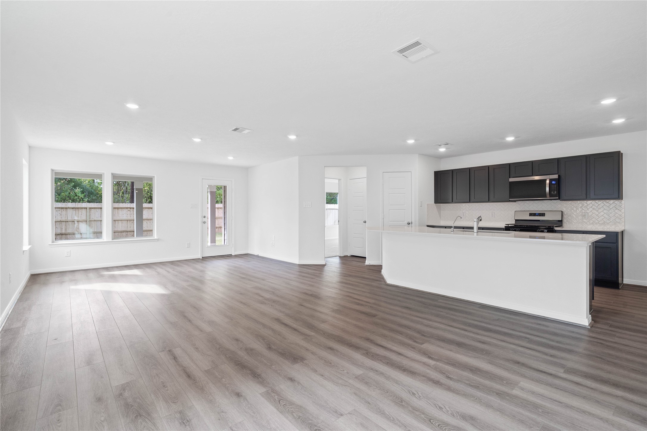 Stunning open-concept design seamlessly connecting the living, dining, and kitchen areasperfect for both everyday living and entertaining!