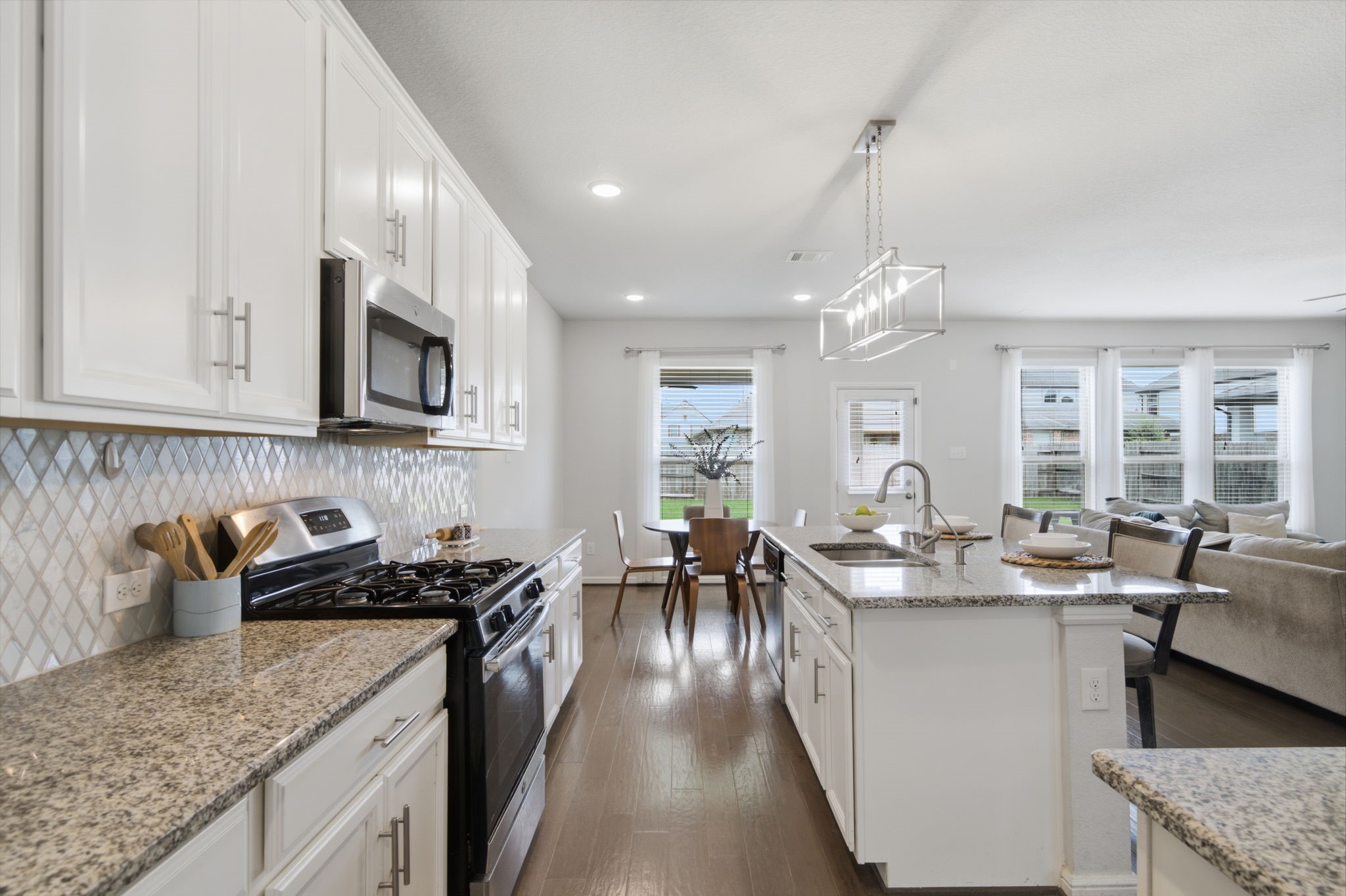 Gourmet kitchen with quartz countertops, a spacious island and stainless steel appliances. Gourmet kitchen with quartz countertops, a spacious island and stainless steel appliances.