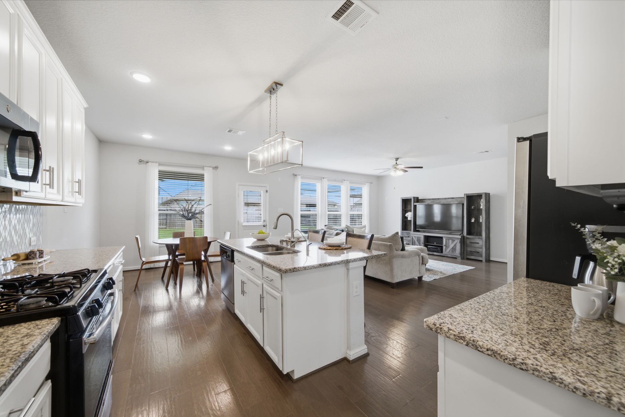Open-concept floorplan featuring a modern kitchen overlooking the living room which helps keep everyone stay connected. Open-concept floorplan featuring a modern kitchen overlooking the living room which helps keep everyone stay connected.
