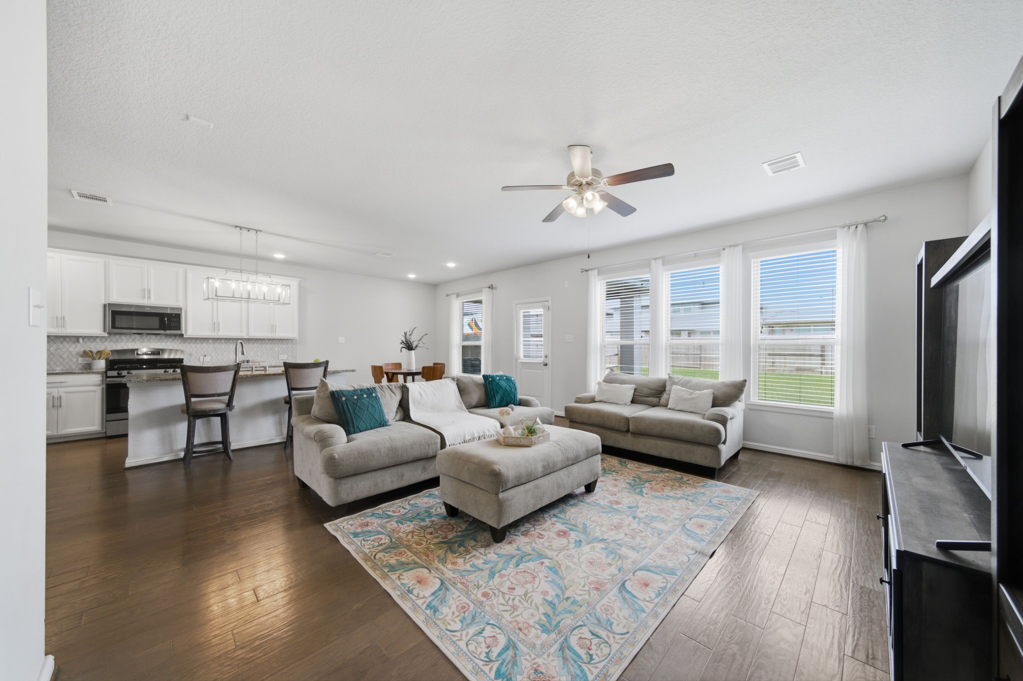 Spacious living area with a wall of windows allowing for plenty of natural light to come in. Spacious living area with a wall of windows allowing for plenty of natural light to come in.