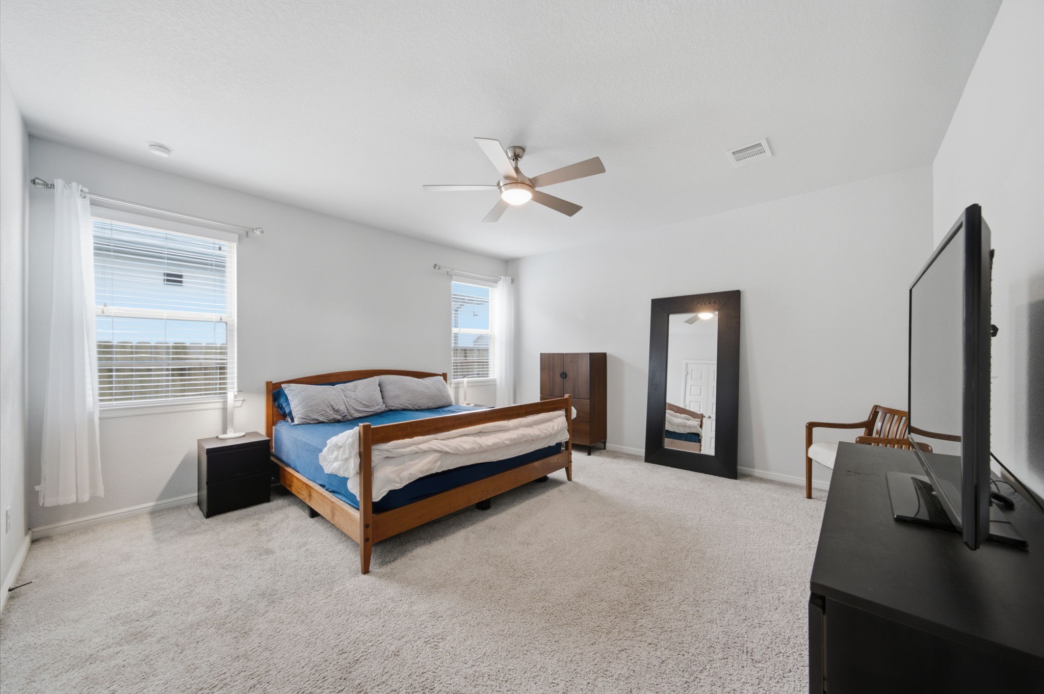 Large primary bedroom is spacious enough for all of your furniture, including a designated sitting area.