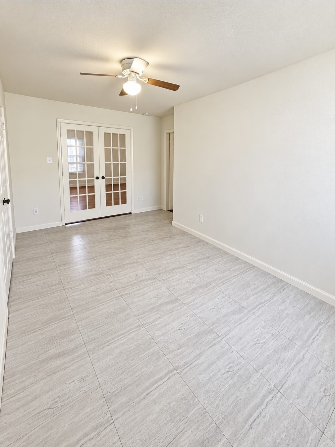 Spacious bedroom/office with double doors just off the main living area and hallway.