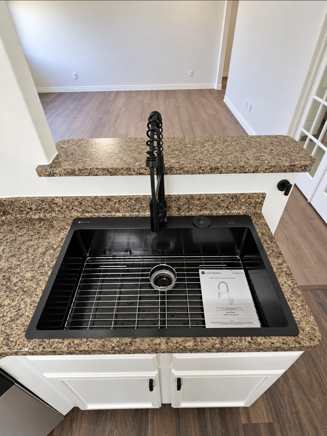 Brand new oversized sink with protector sink grid.