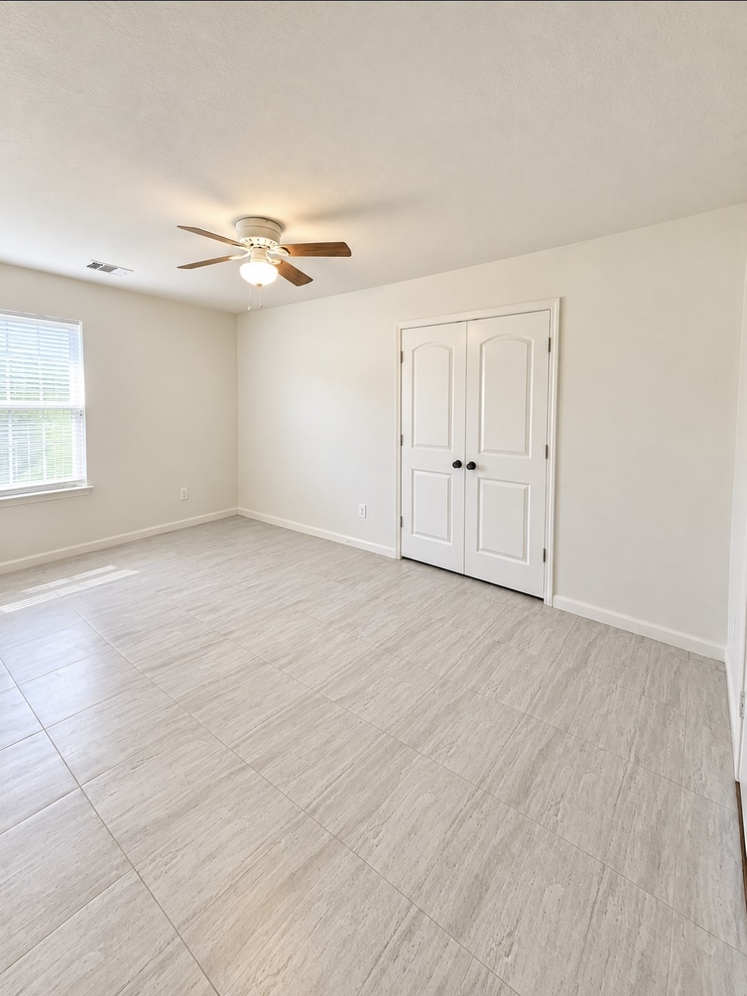 Spacious bedroom/office with double doors just off the main living area and hallway.