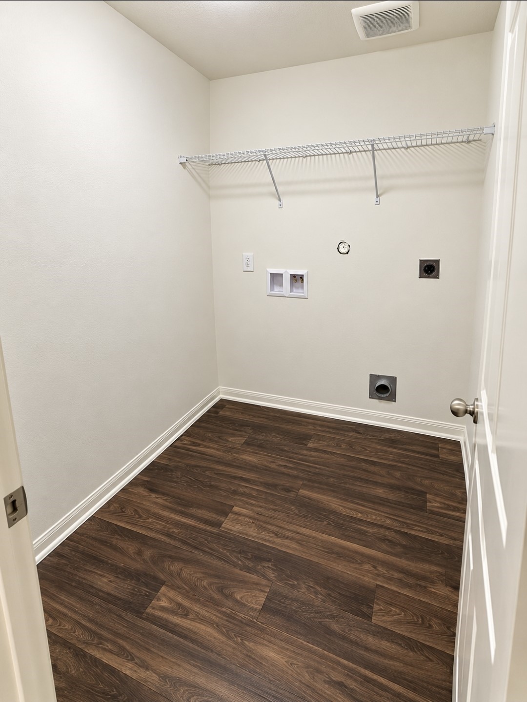 In-house utility room with storage shelve.