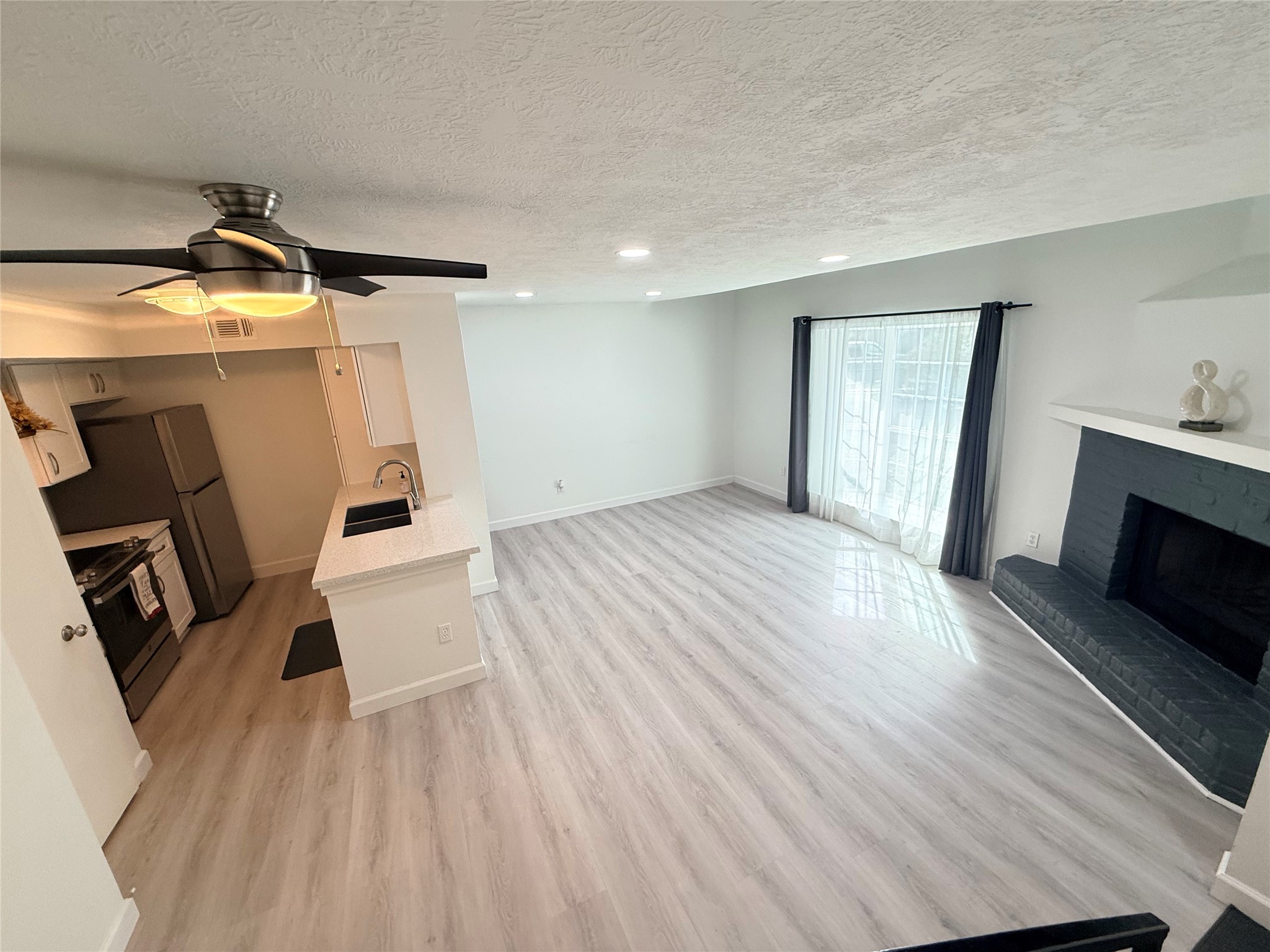 View from stairs looking at the large open living room and kitchen!