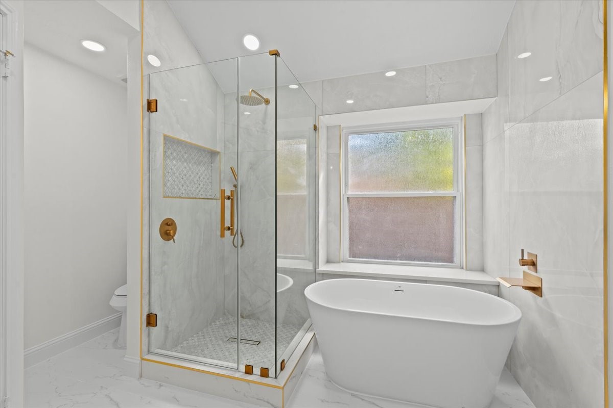Primary restroom with stand alone tub and shower