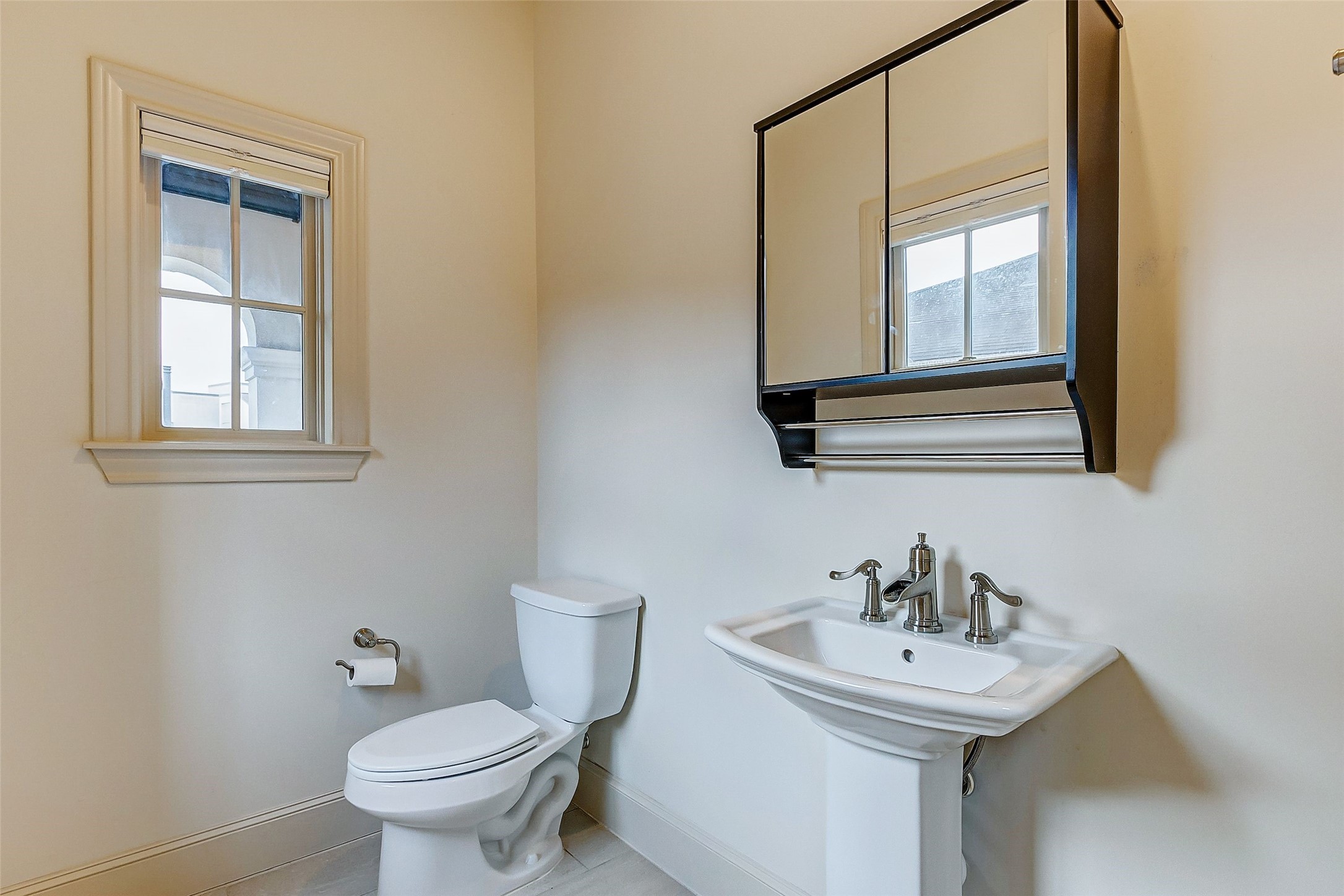 Conveniently located off the dining area, this stylish powder room ensures easy access and comfort for your guests.