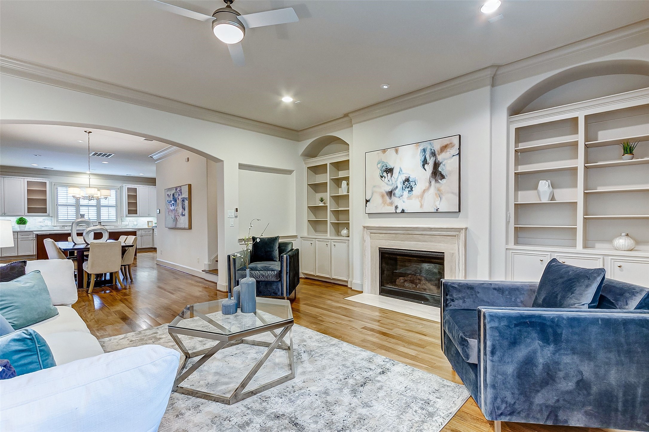 Elegant custom built-ins illuminate the room, offering a perfect showcase for your cherished book collection or favorite knick-knacks.