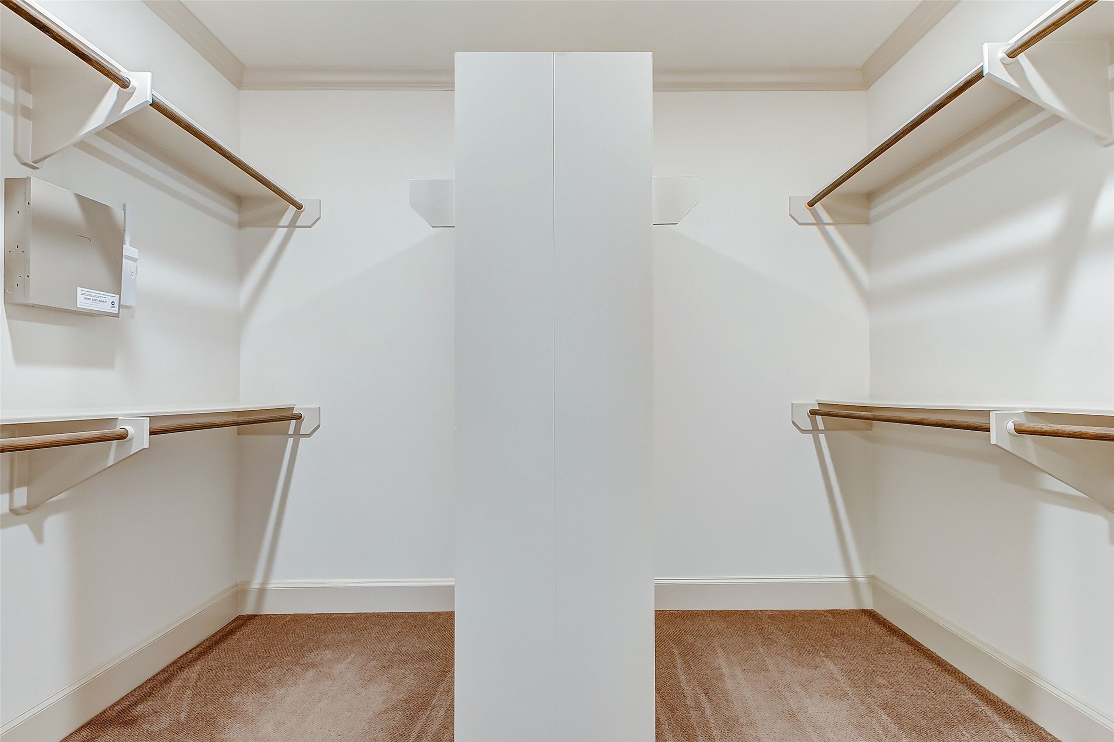 Discover the luxury of a primary bedroom boasting an expansive walk-in closet equipped with double-sided clothes rods, perfect for organizing your wardrobe with ease.