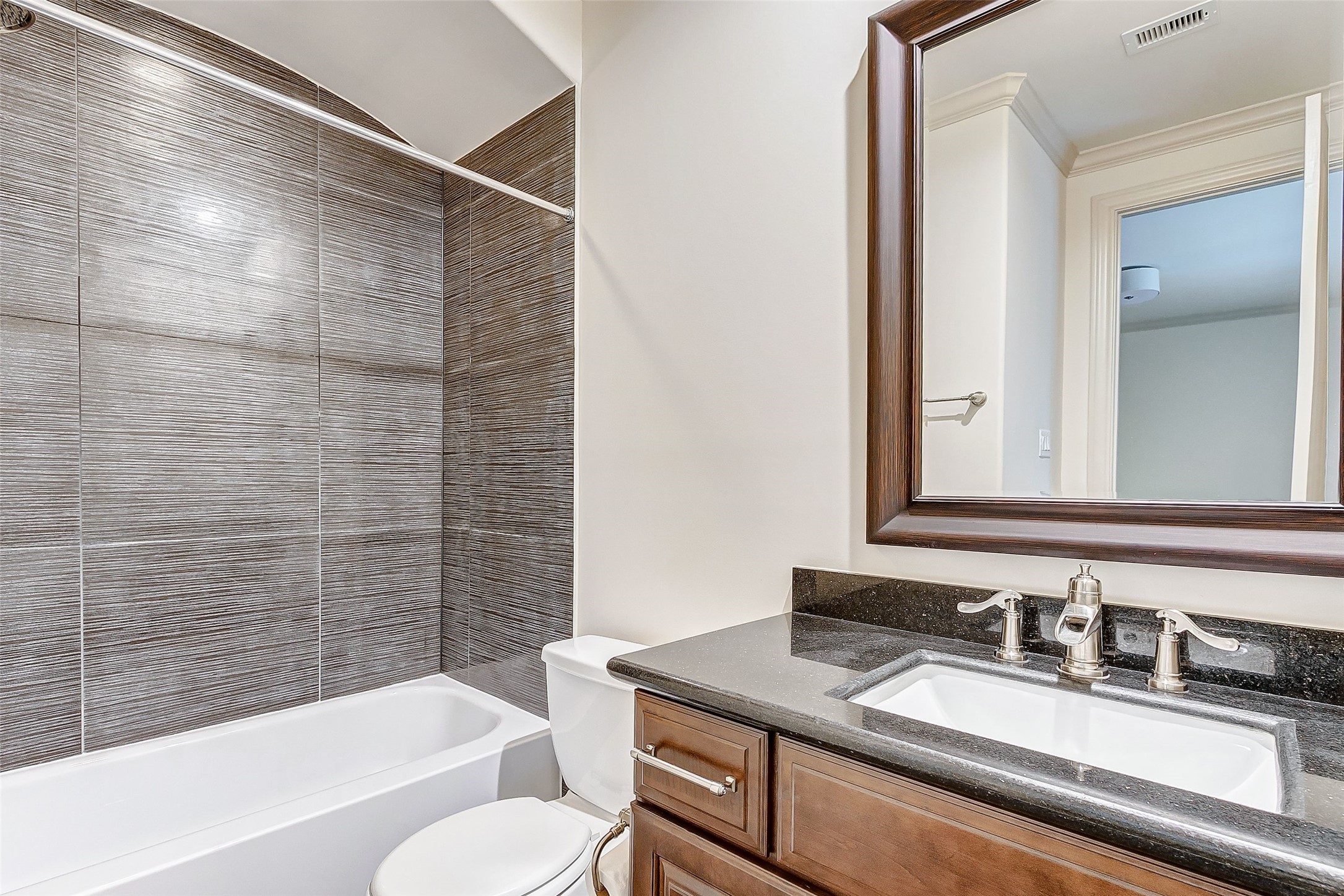 Experience modern elegance in the nearly brand-new, remodeled secondary bathroom on the third floor, featuring sleek finishes and a stylish design.