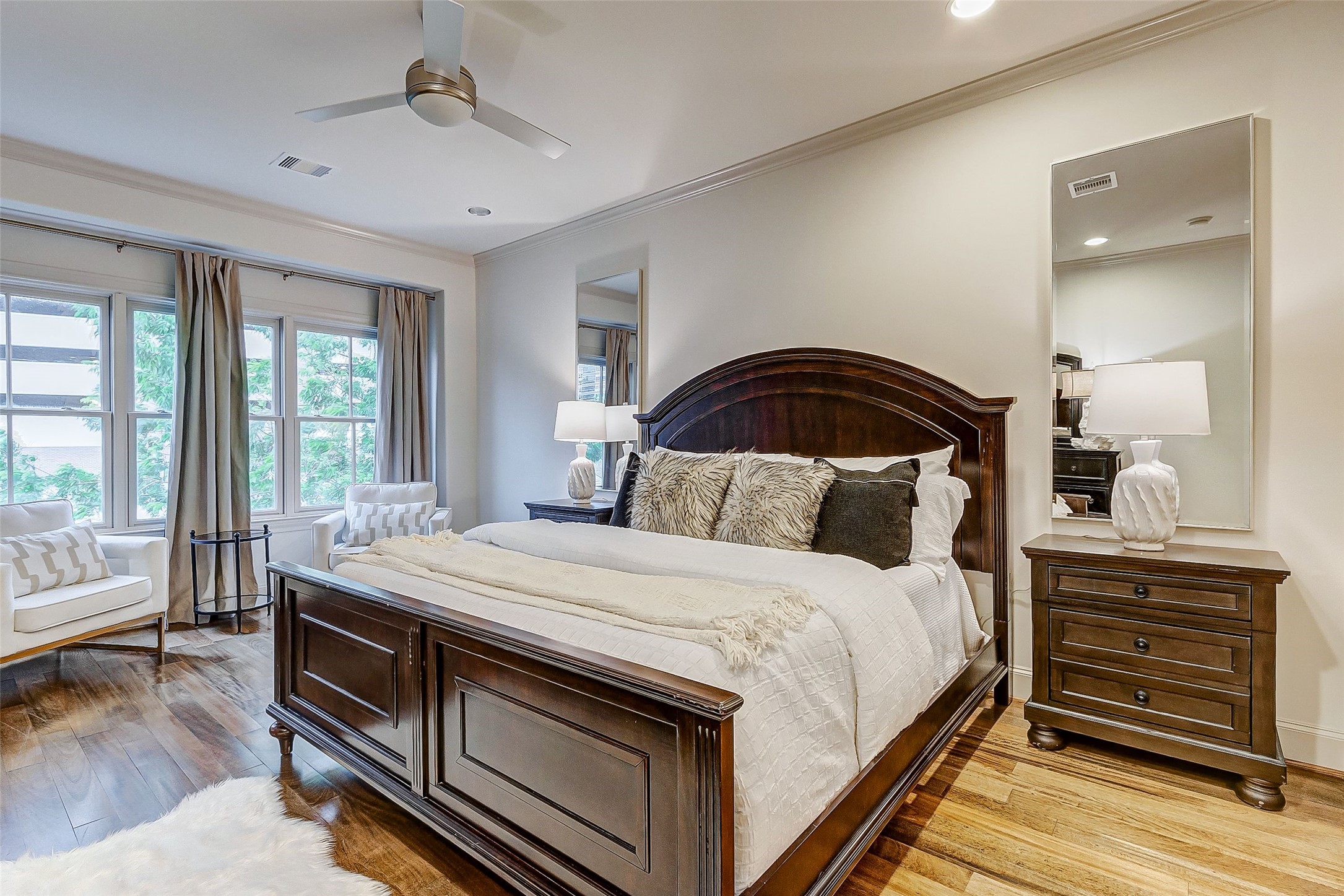 Experience the inviting warmth of this spacious primary bedroom, bathed in abundant natural light.