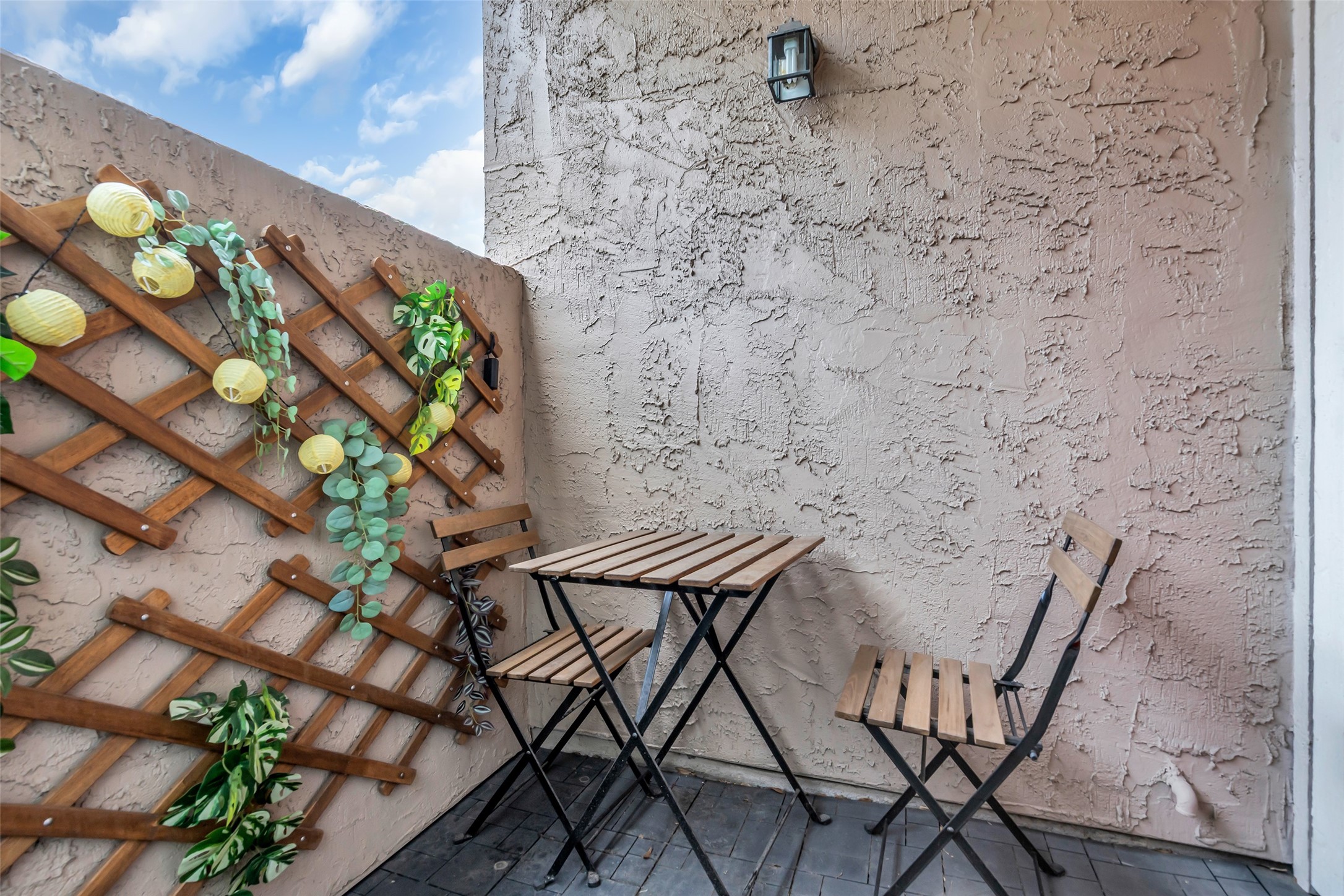 Step outside to a private sitting area that provides additional space to enjoy some fresh air, relax with a cup of coffee, or create a cozy outdoor setup.