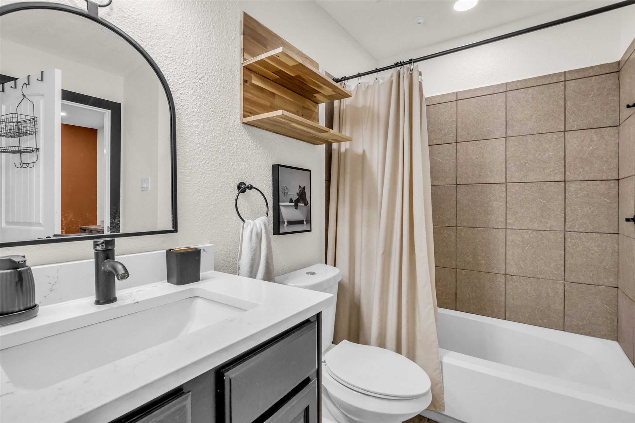 The bedroom includes a private en suite bathroom with a convenient tub and shower combination.