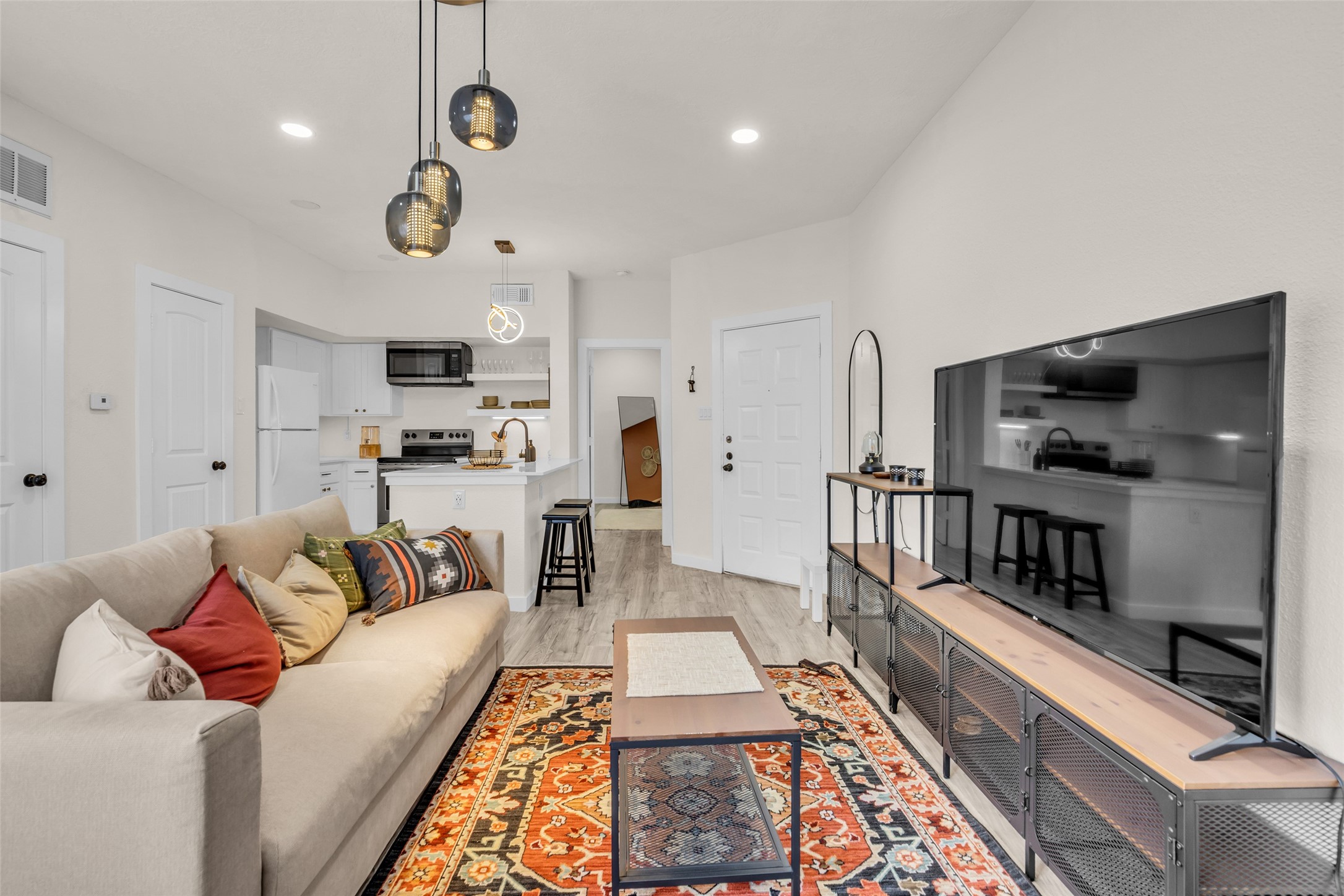 This updated condo features a comfortable living room with a bright, inviting feel, making it a great space to relax or entertain.