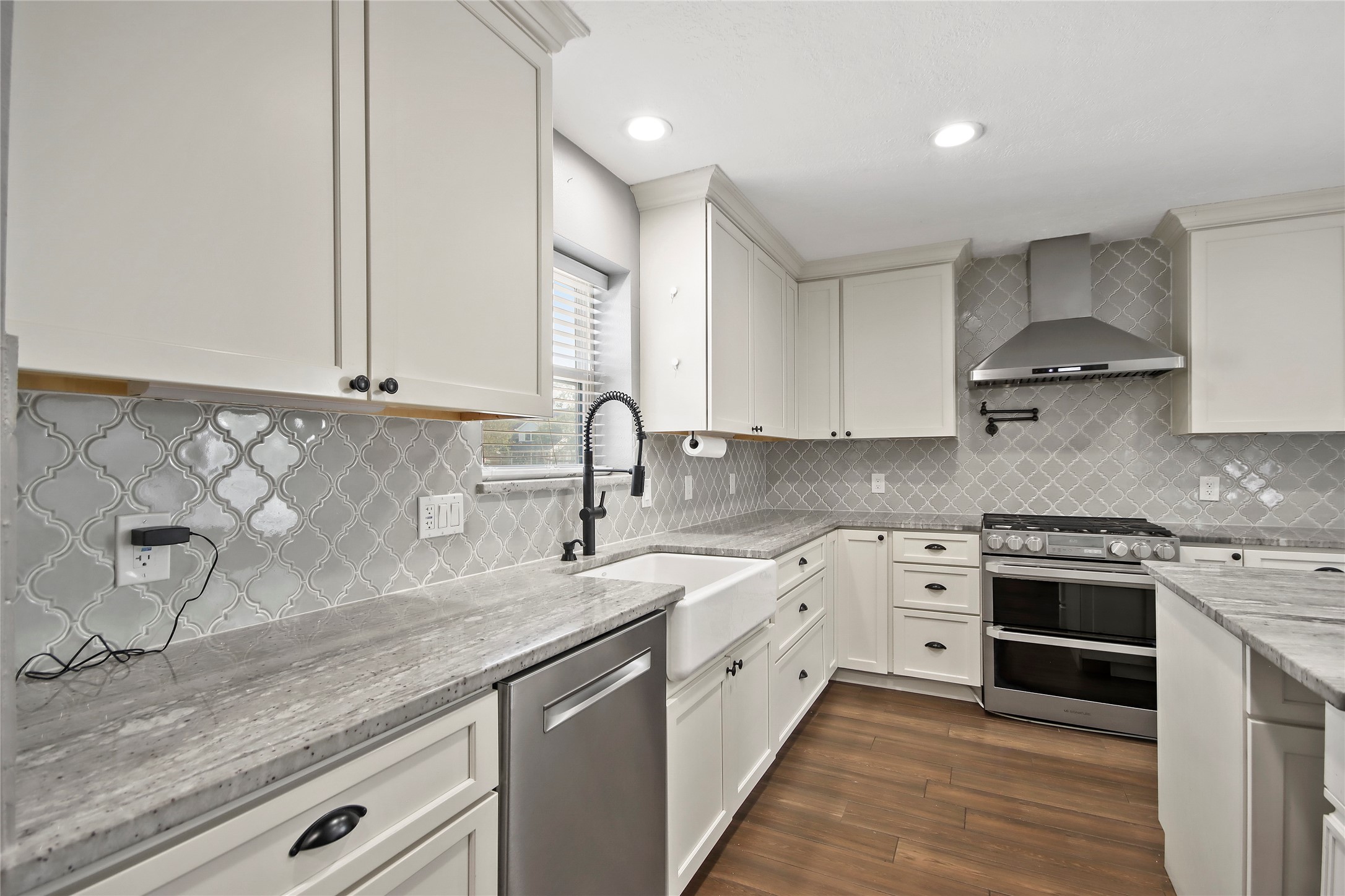 Arabesque tile backsplash and crisp white cabinetry add a designer touch throughout the kitchen. Arabesque tile backsplash and crisp white cabinetry add a designer touch throughout the kitchen.