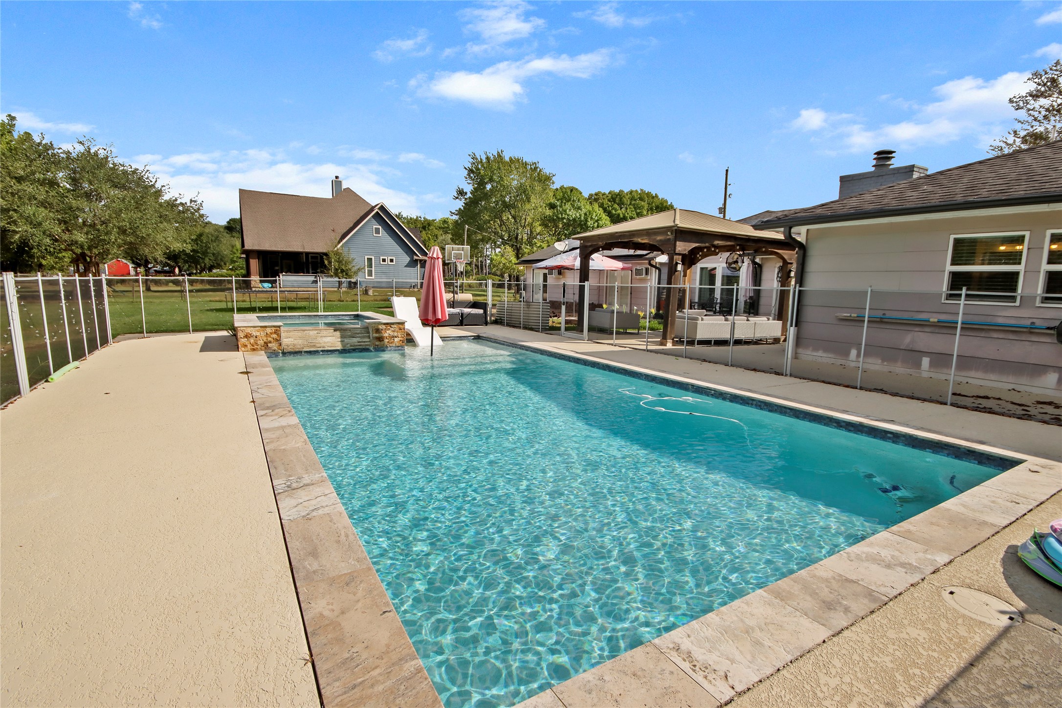 The sparkling pool is the backyard's centerpiece, complete with a raised spa, water features, and plenty of deck space for lounging. The sparkling pool is the backyard's centerpiece, complete with a raised spa, water features, and plenty of deck space for lounging.