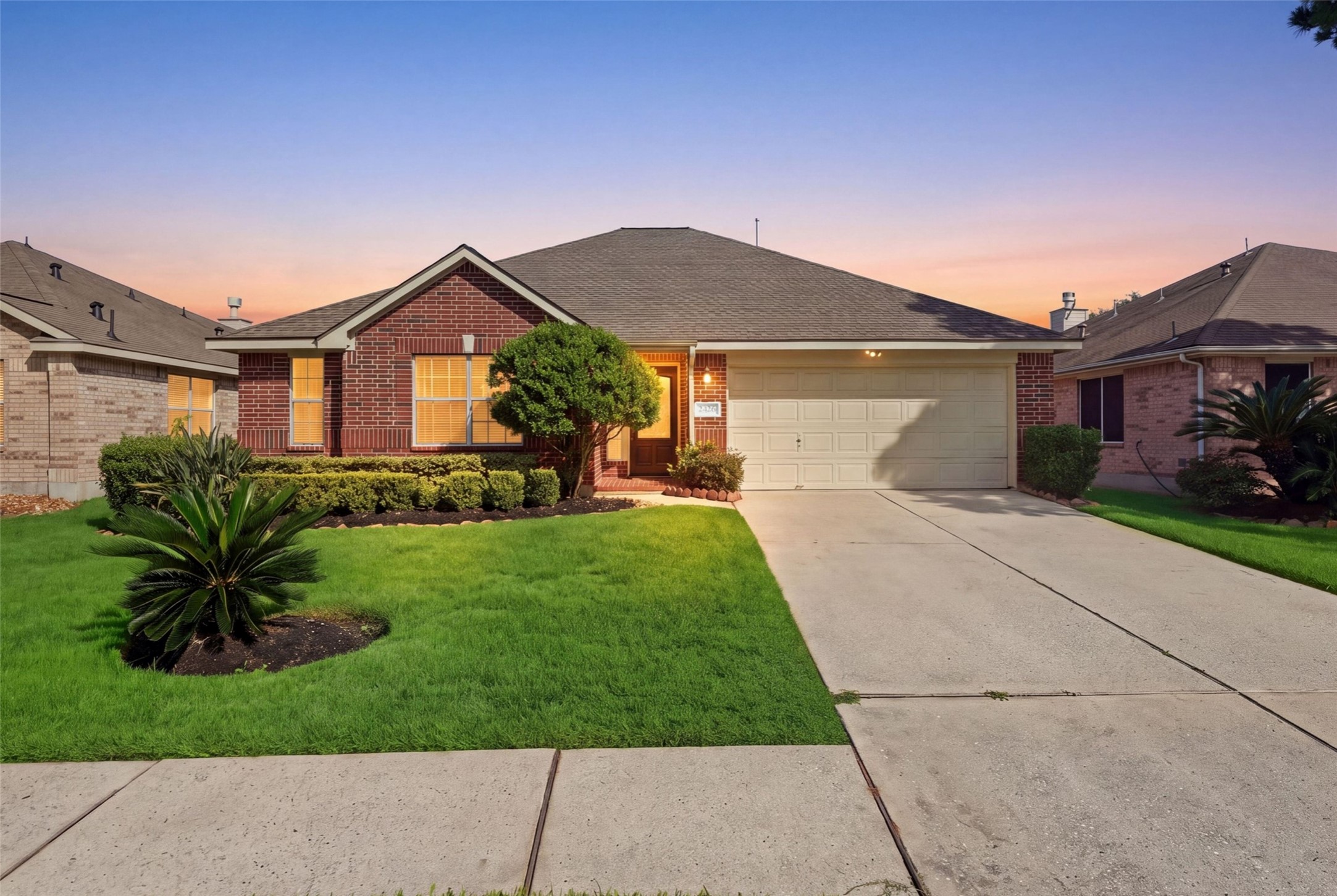 Classic single-story brick elevation featuring manicured landscape beds, mature palmettos, and prime curb appeal.