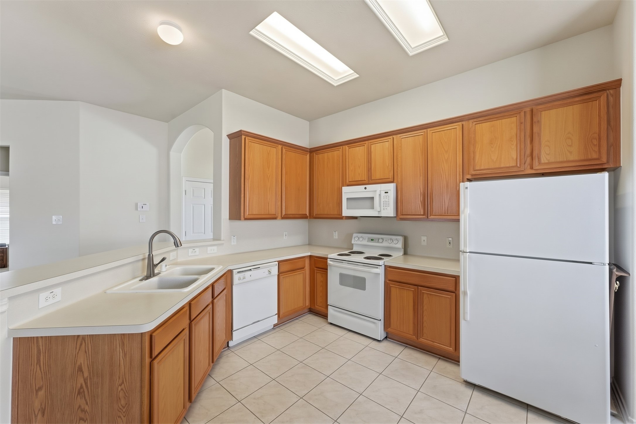 Bright kitchen with ample cabinetry, and a convenient layout perfect for cooking and entertaining.