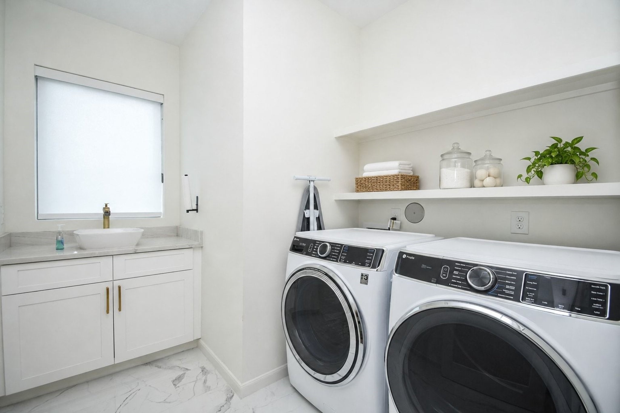 Your roomy utility space easily hosts dual appliances, with the addition of a counter top sink and big window --- nice surroundings on laundry day!