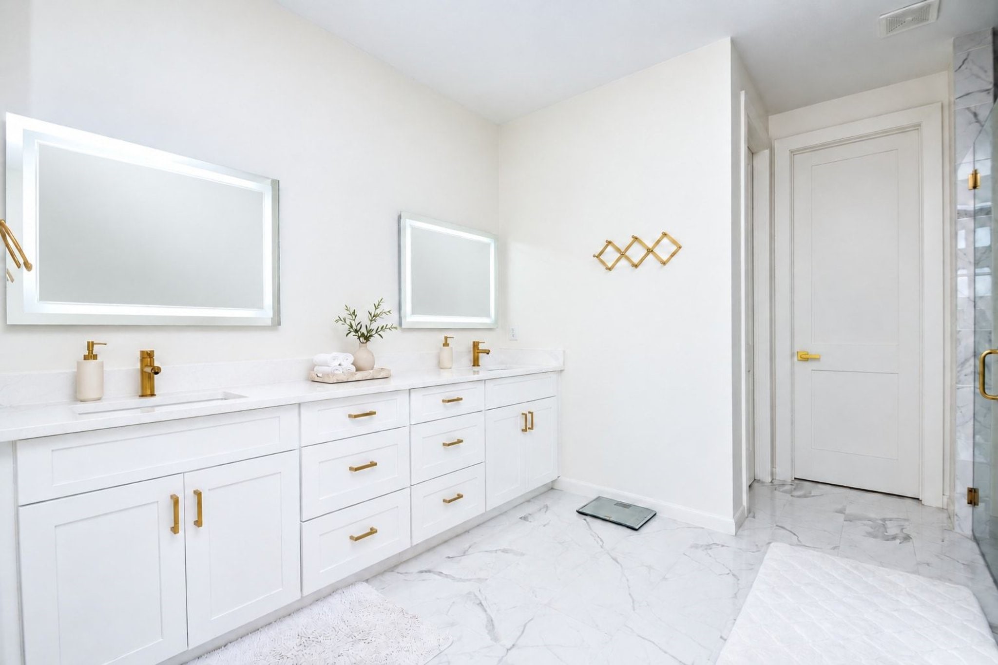 Your primary ensuite bathroom is a magical, tranquil study in pure white --- which somehow imparts a secure, cozy feeling. Sometimes, basics are best. The long counter features dual sinks/great storage below and two striking framed wall mirrors, above.