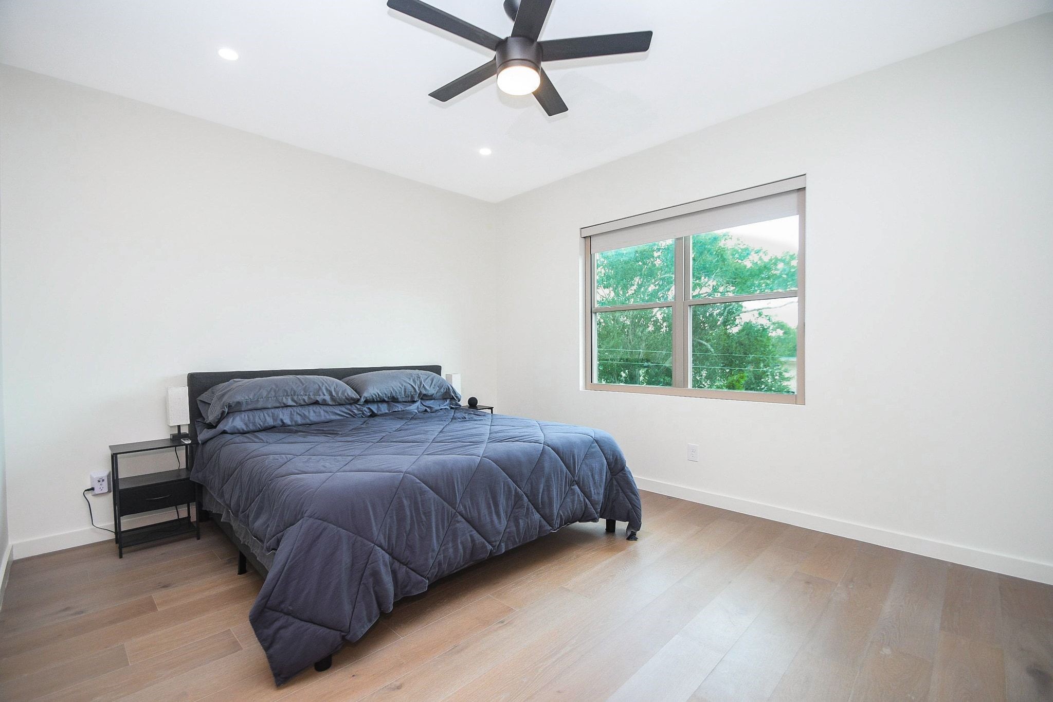 A spacious secondary bedroom invites lots of natural light and generous wall/floor space.