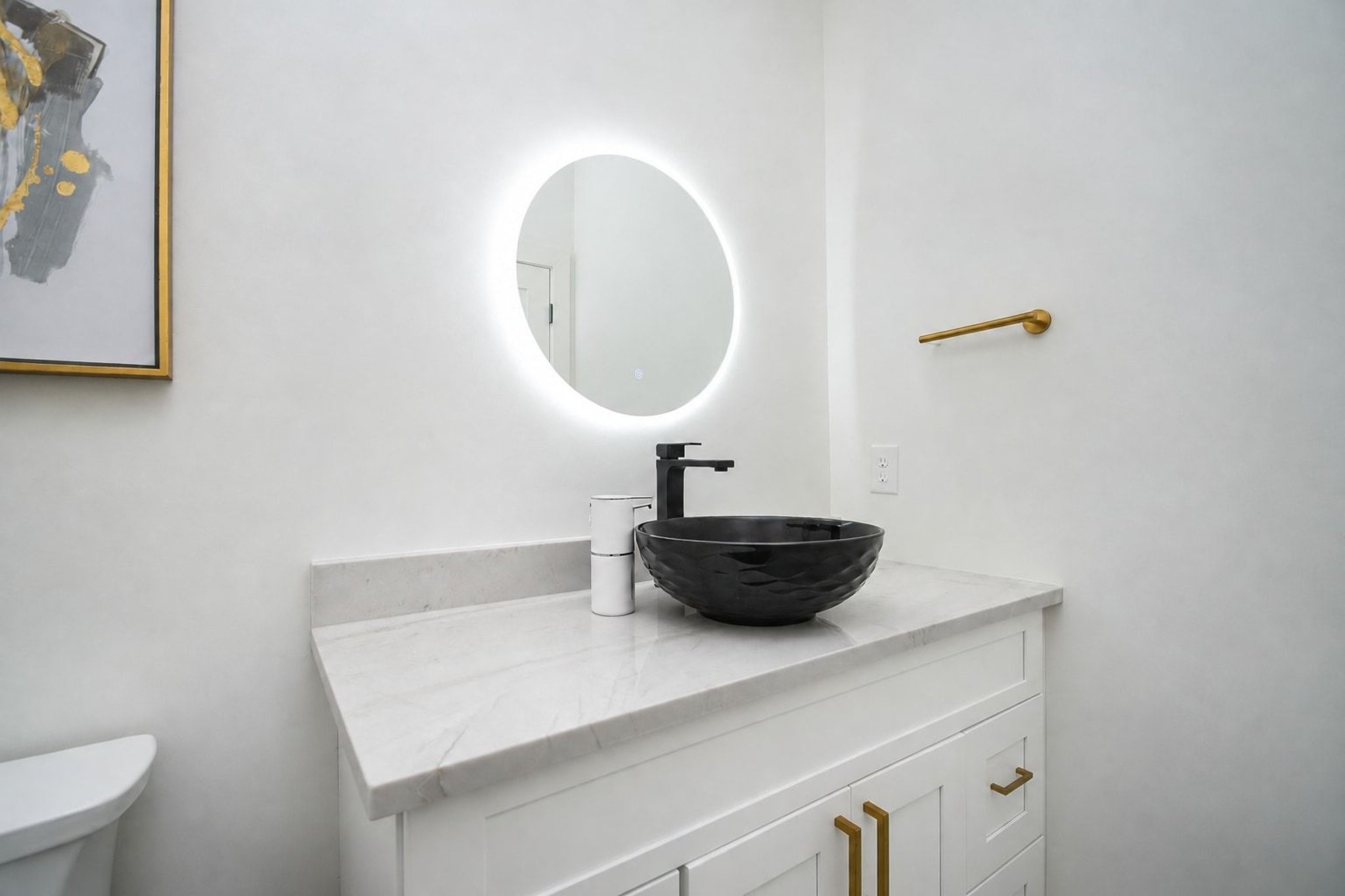 A secondary bathroom features streamlined adaptations of the home's contemporary theme.