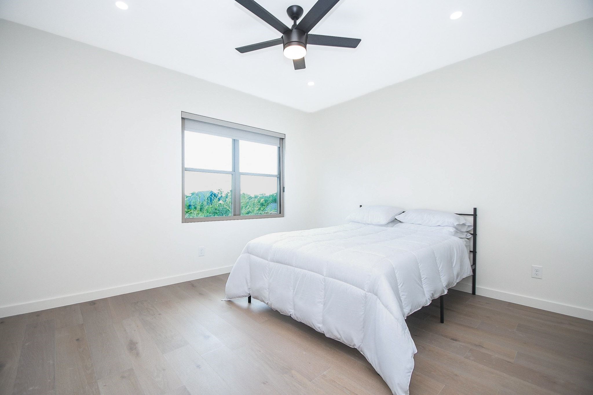 A cleverly placed corner window in a secondary bedroom leaves more wall space for your favorite bedroom decor.