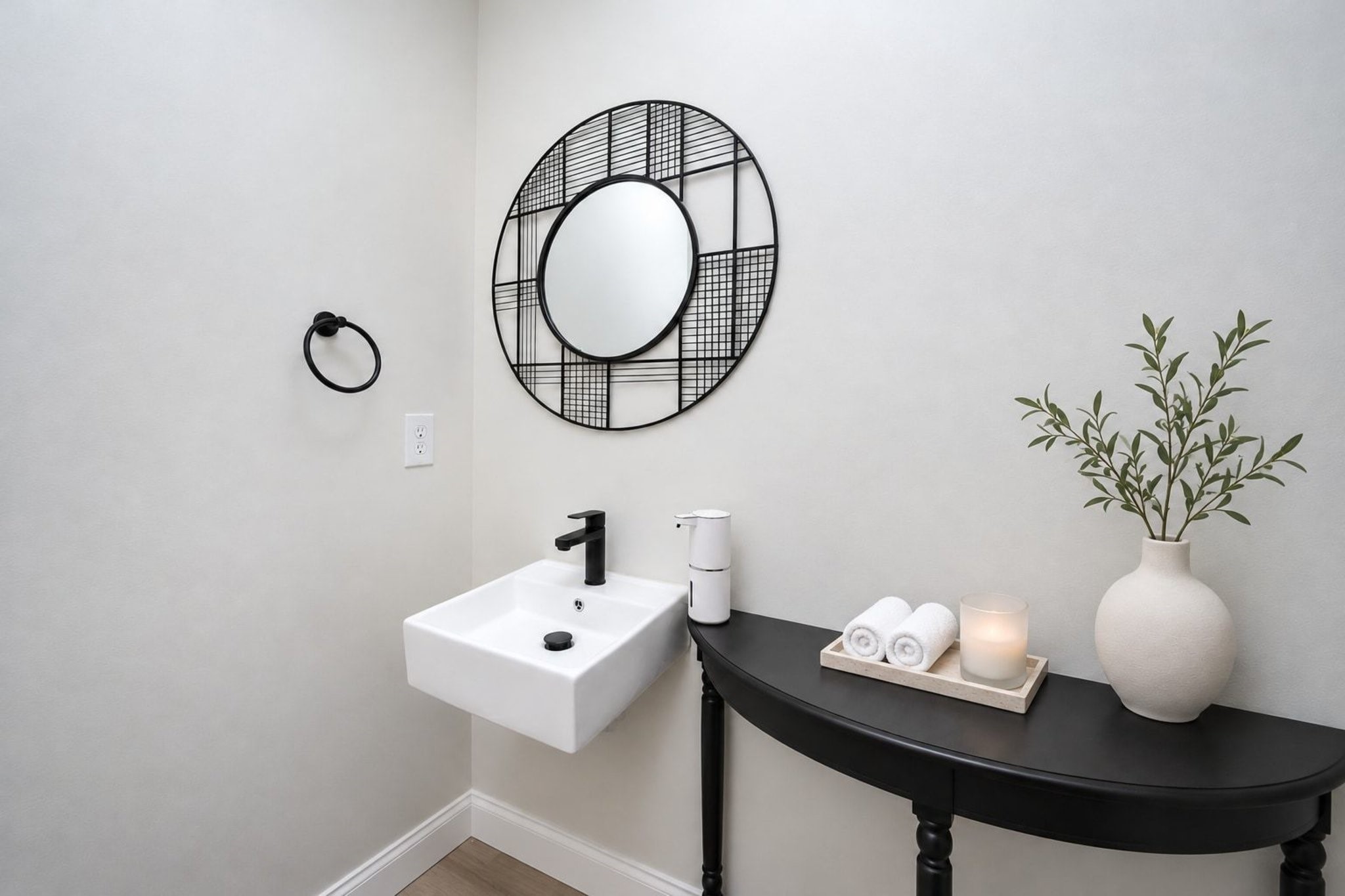 15-This darling half-bath repeats the home's appealing minimalist theme.