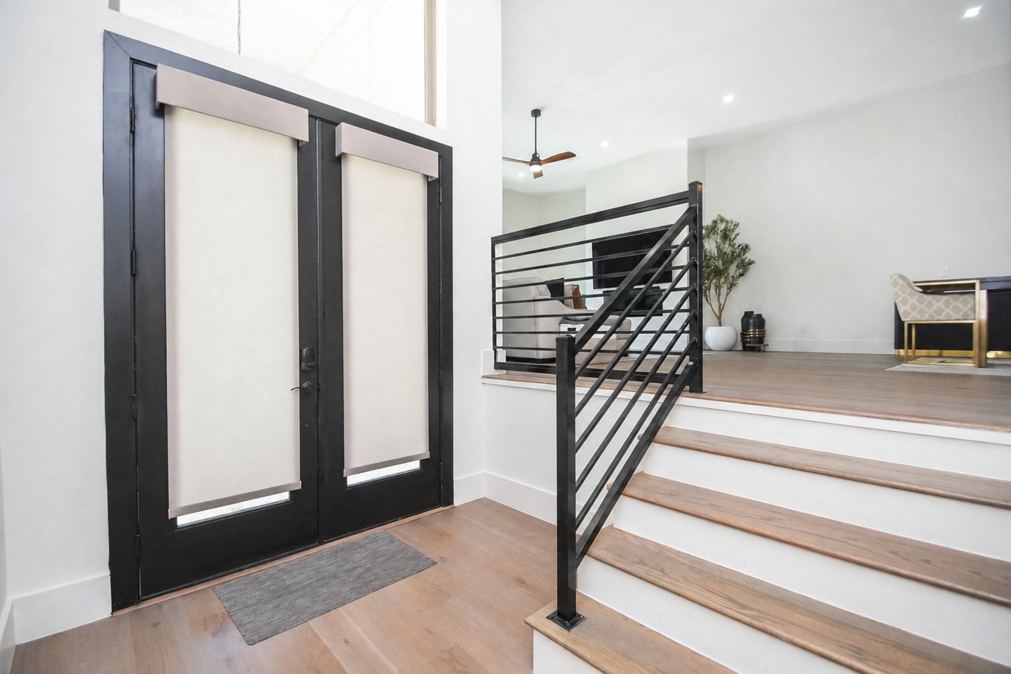 Modern structural simplicity invites us in while displaying easy elegance in this inside view of the front entry.