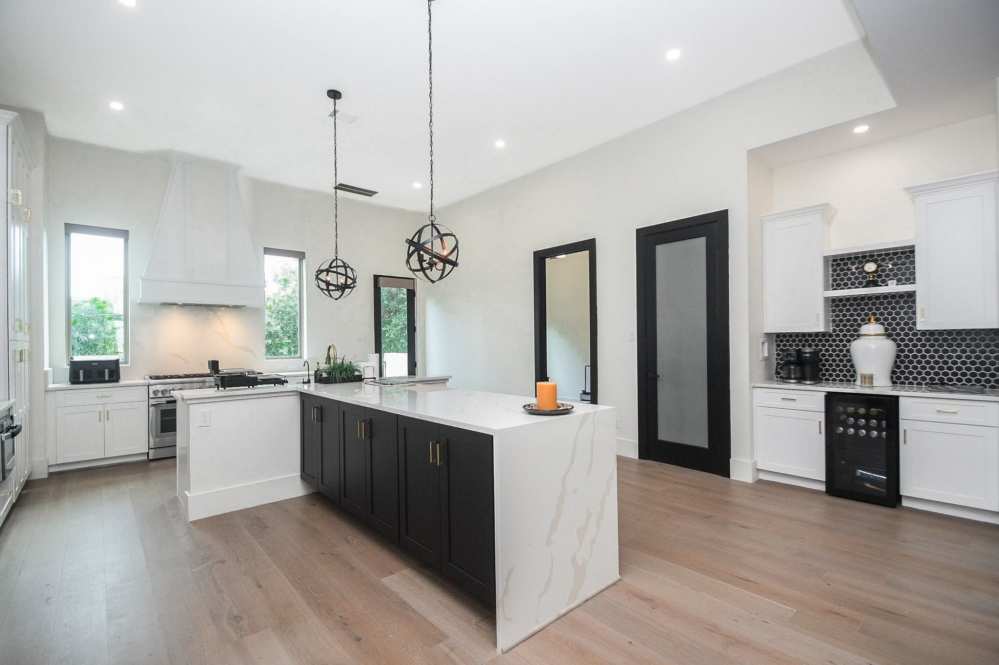 Here's another wide open view of the kitchen --- a striking study in practical black and white.