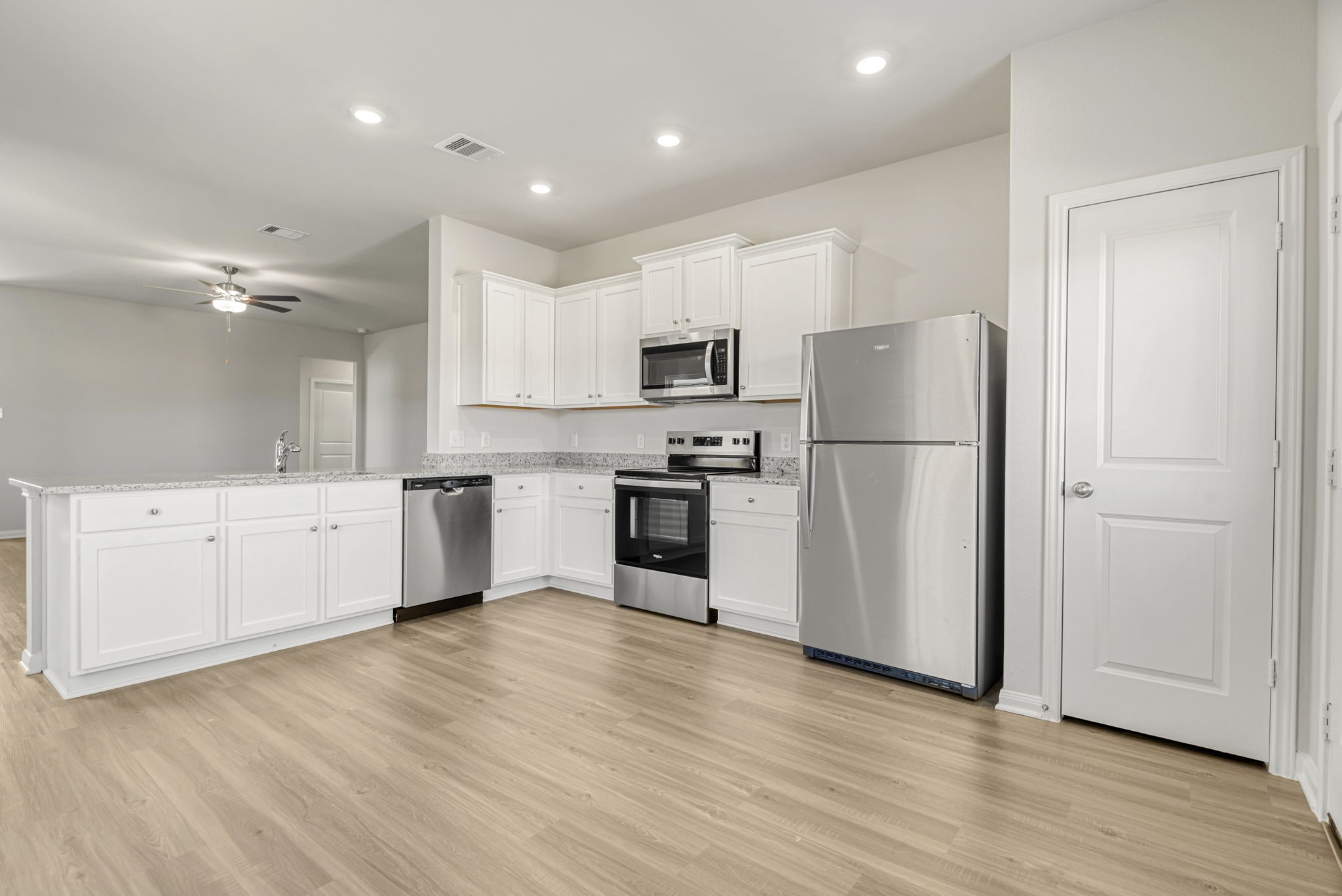 Whirlpool kitchen appliances and granite countertops make this kitchen chef-ready!