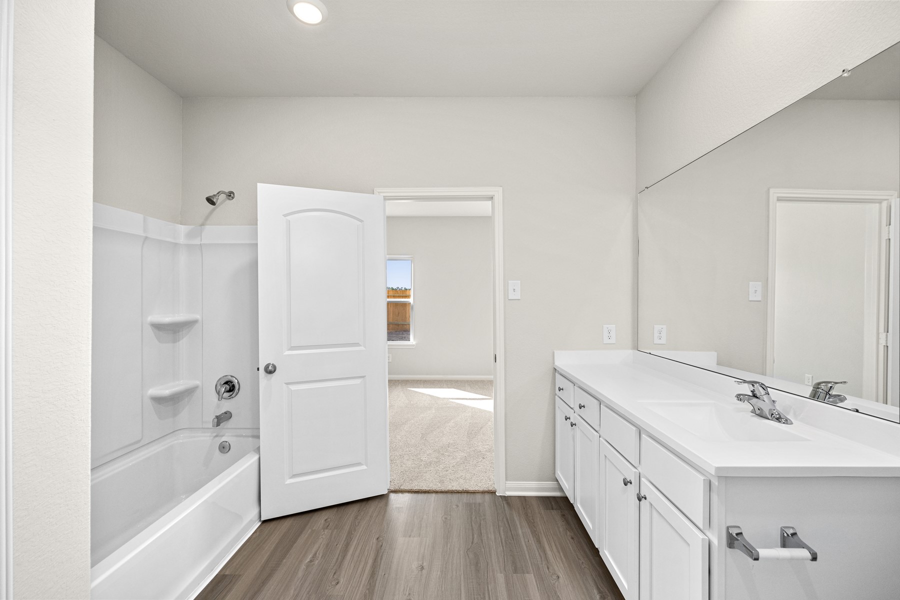 The primary bathroom has tons of room with a walk-in closet and plenty of storage space.