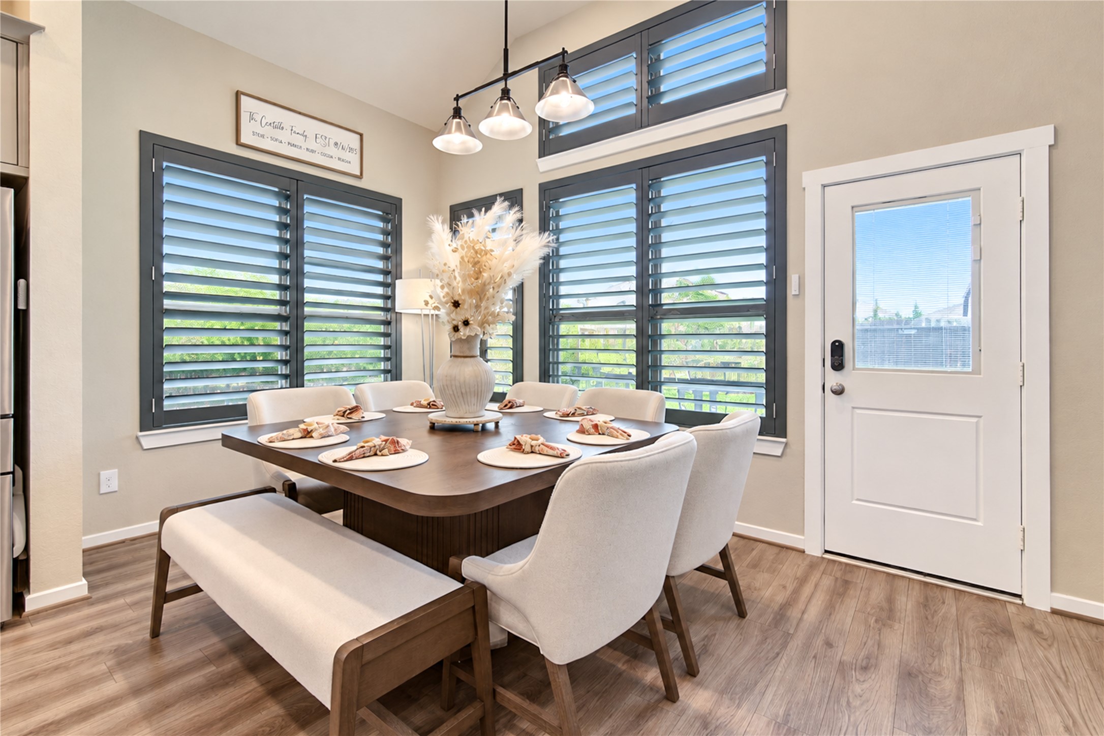 A bright, welcoming dining area with high ceilings, plantation shutters and easy access to the backyard.