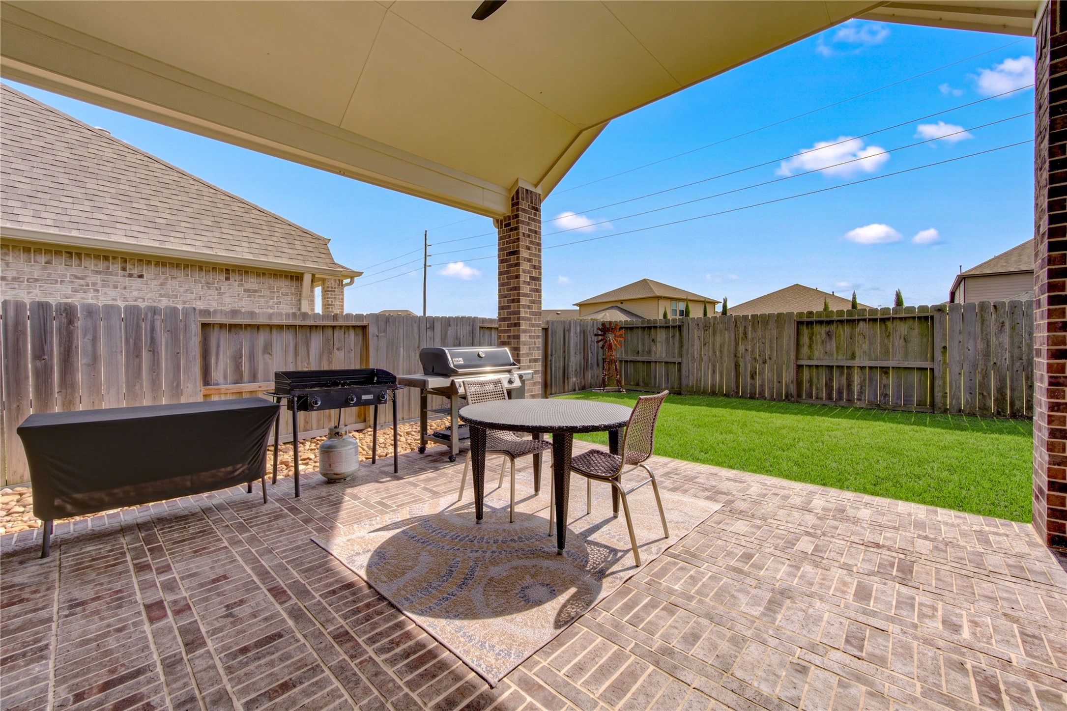 A covered patio offers a comfortable outdoor space for relaxing or casual entertaining.