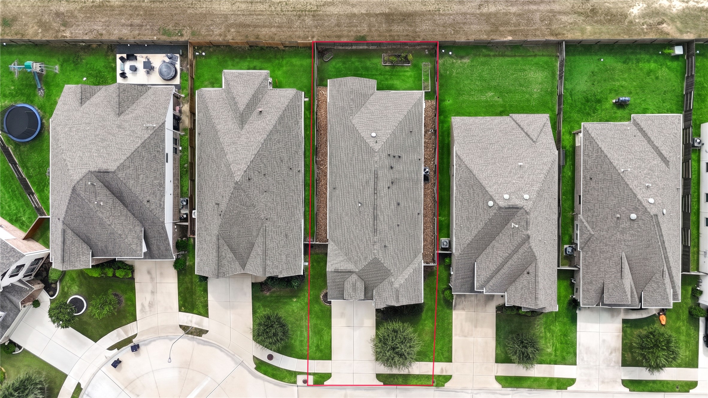 An overhead look at the property, showing the home's footprint, fenced backyard and lot layout.