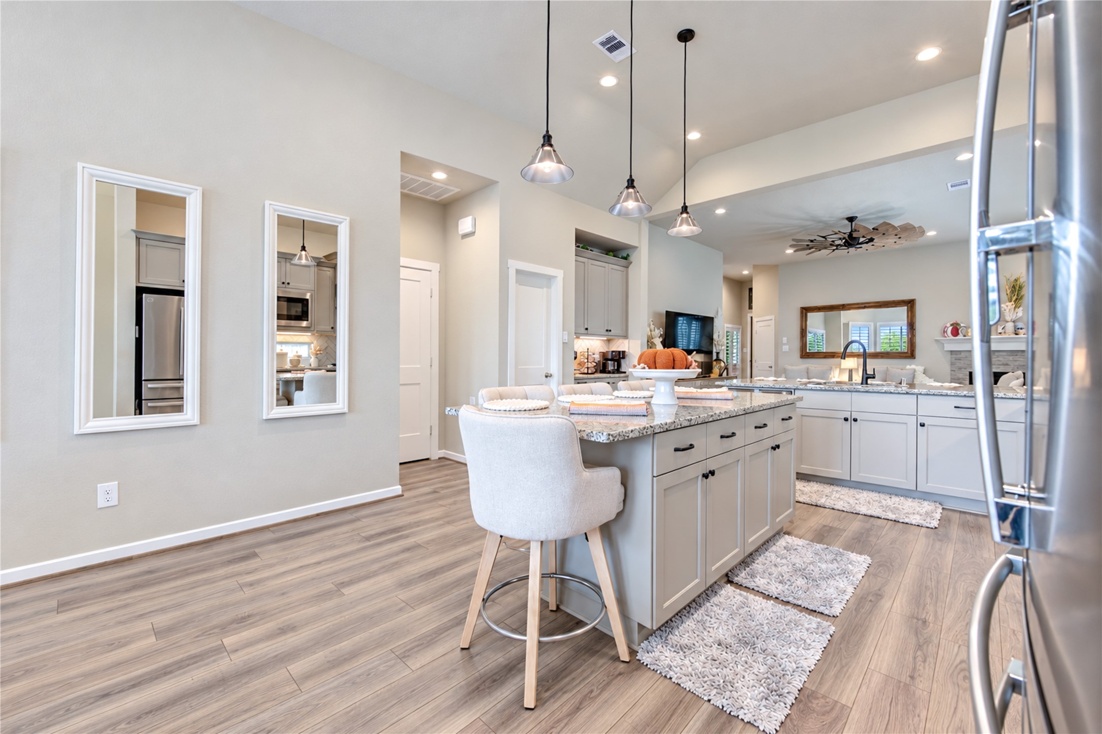 A generous center island provides additional seating, storage and workspace, with the family room just beyond.