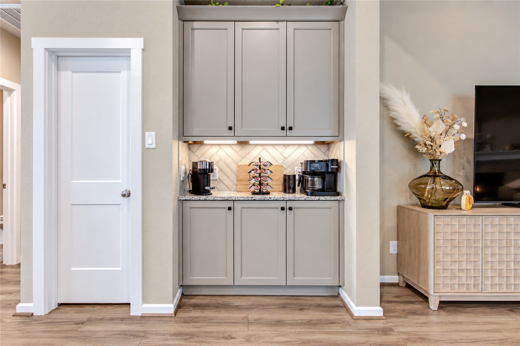 A convenient extension of the kitchen with additional cabinetry, counter space and a dedicated area for coffee or serving.