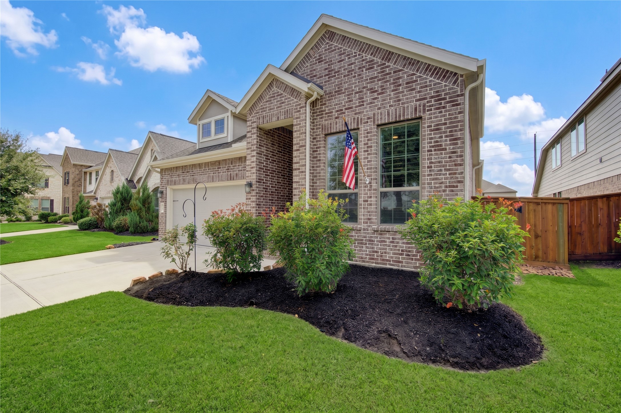 A closer look at the home's attractive brick exterior, welcoming entry and well-maintained landscaping.