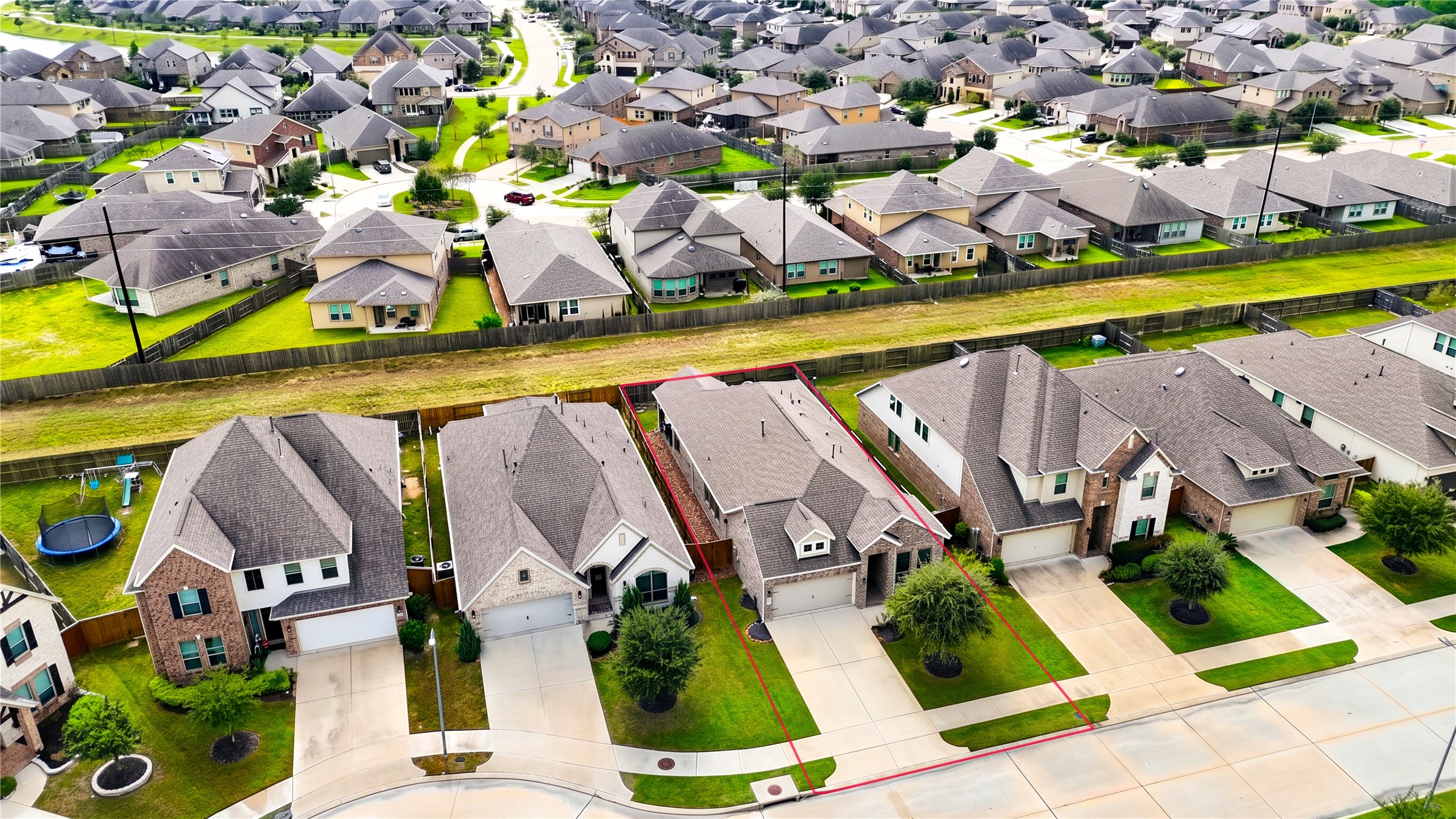 An elevated view highlighting the home's single-story design, lot boundaries and surrounding properties.