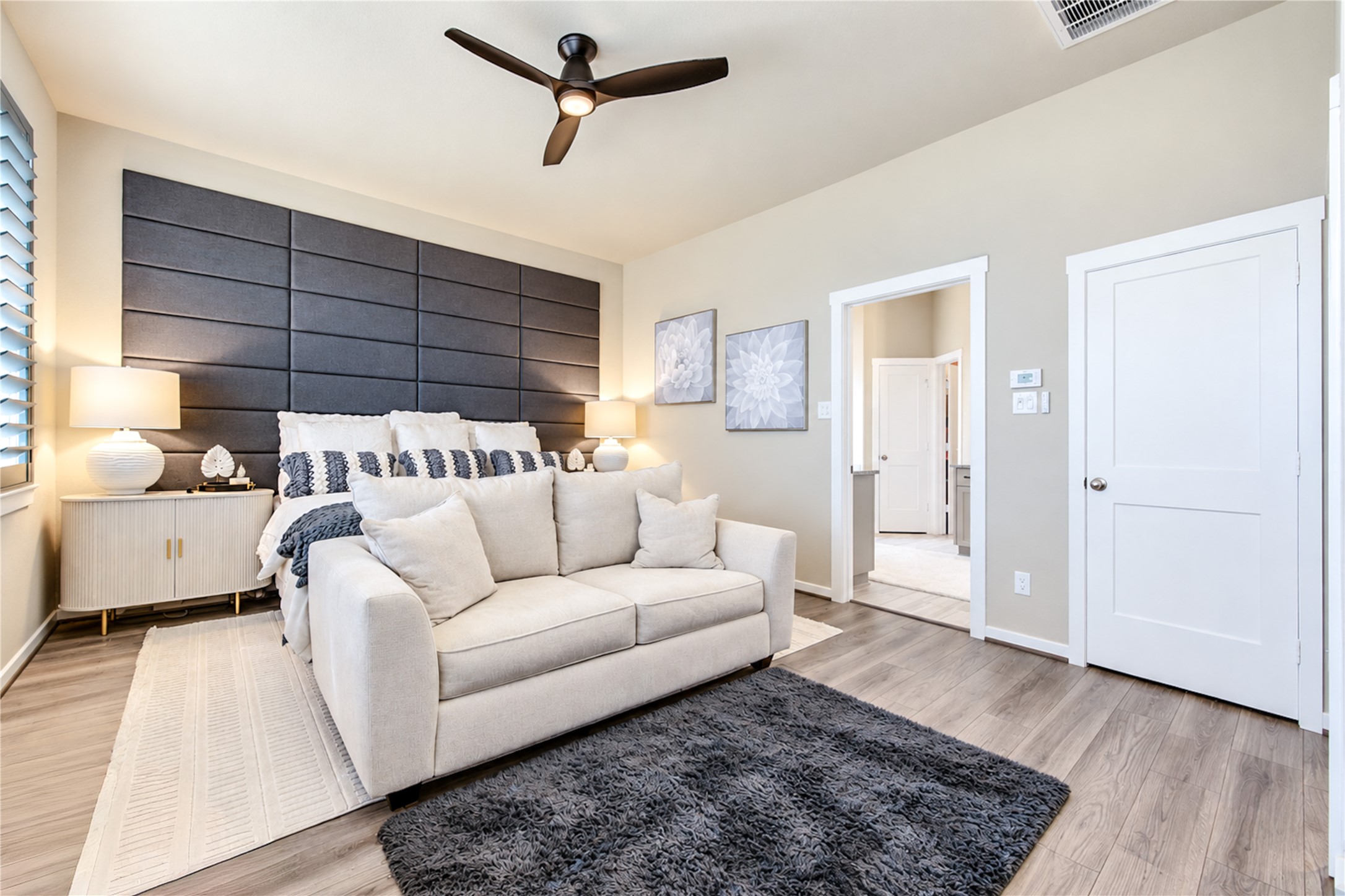 The primary suite offers a comfortable retreat with direct access to the private bath.