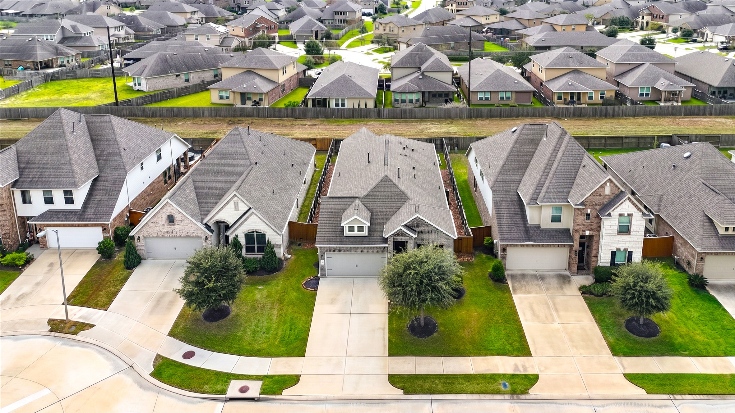 An aerial view of the home and its surrounding neighborhood in Lakes of Bella Terra West.